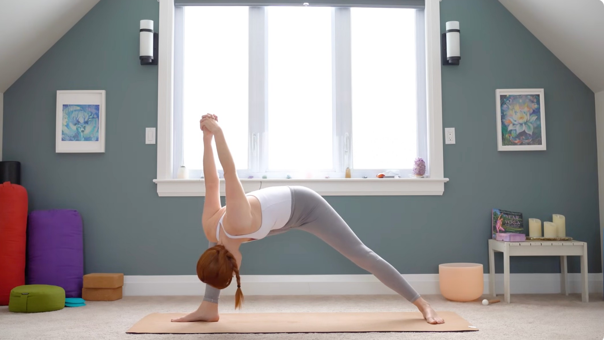 Woman leaning forward in Humble Warrior with her hands clasped behind her back