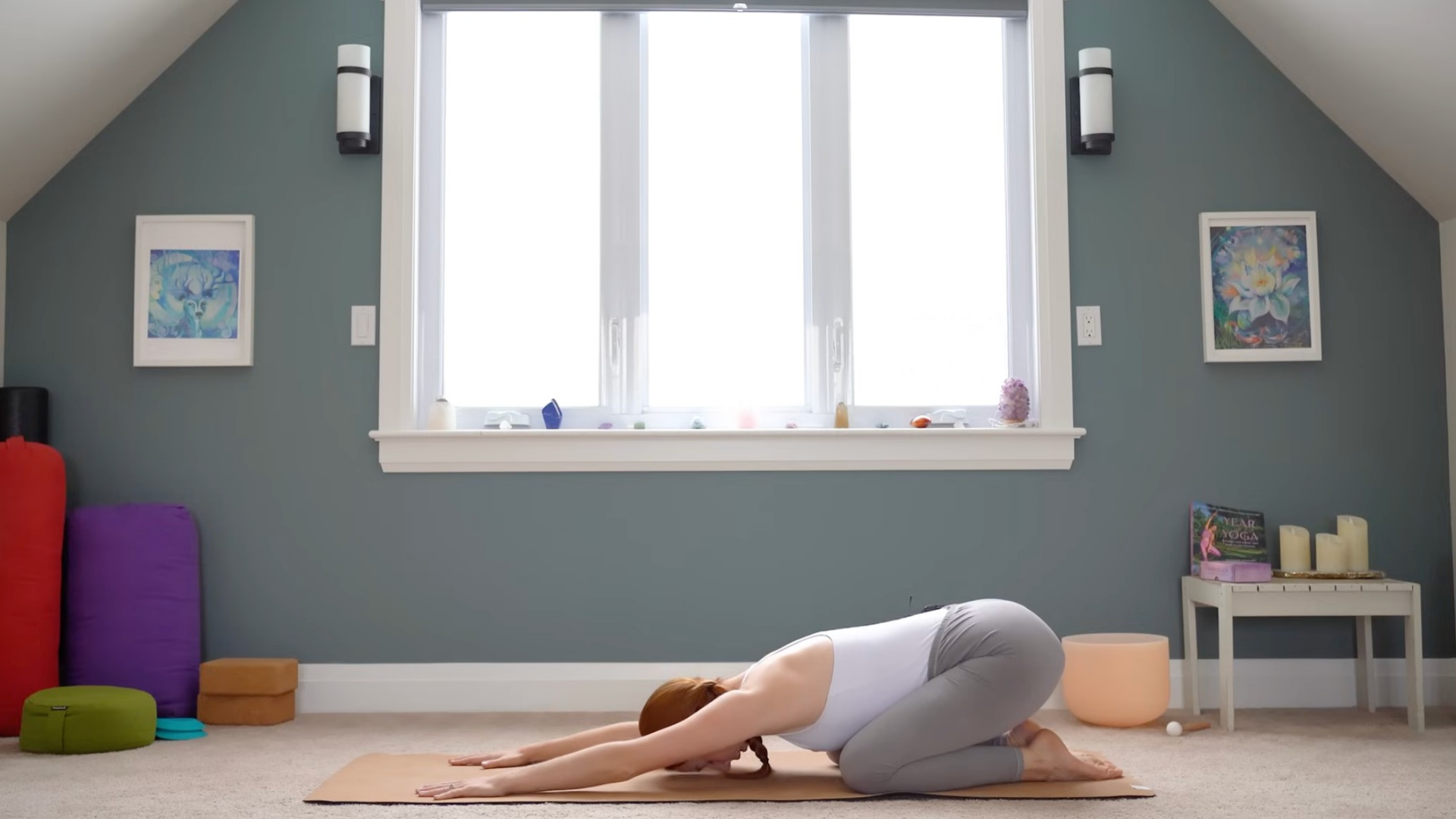Woman kneeling on a mat in Child's Pose