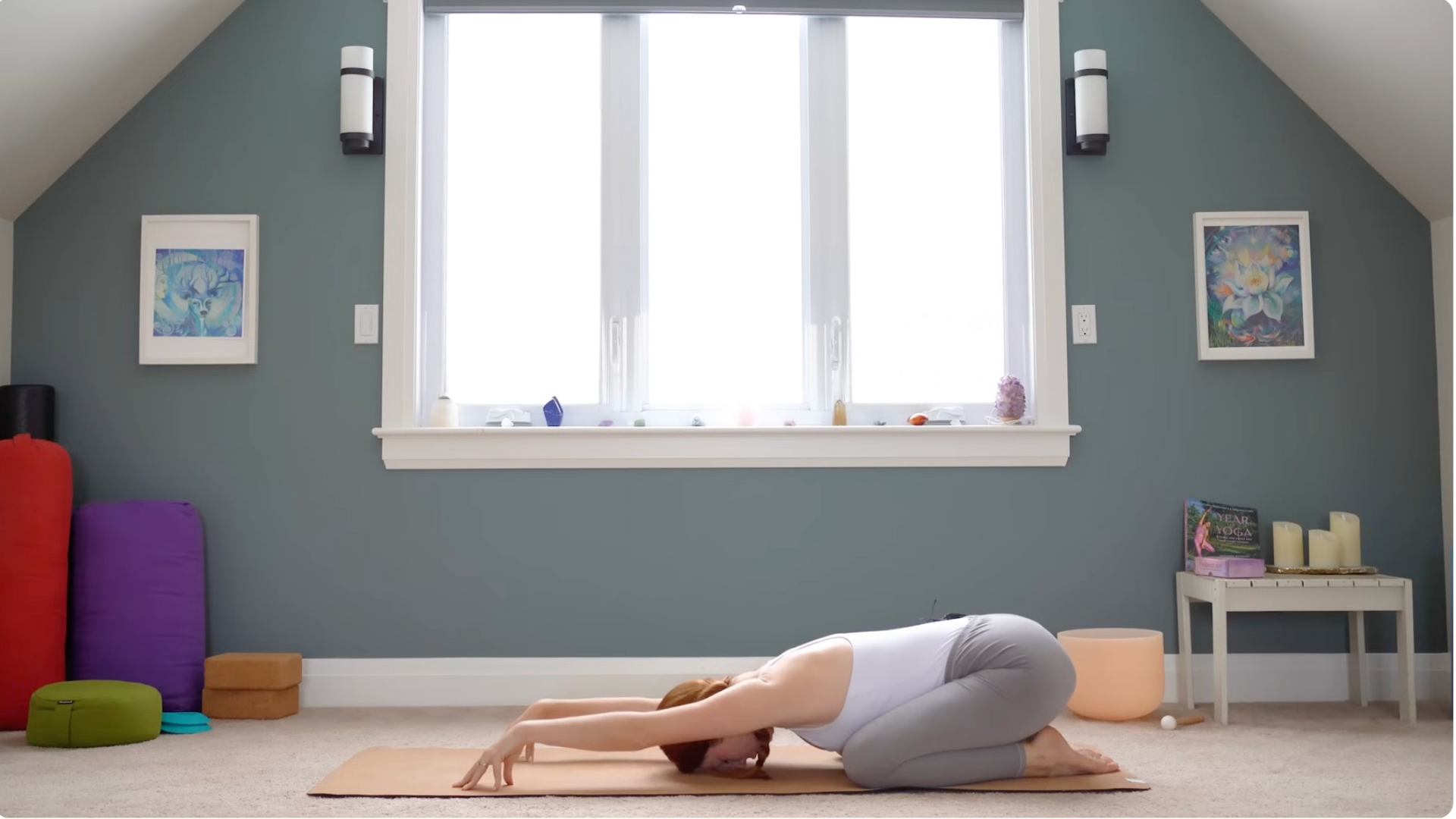 Woman in Extended Child's Pose with her arms in front of her and her palms lifted off the mat
