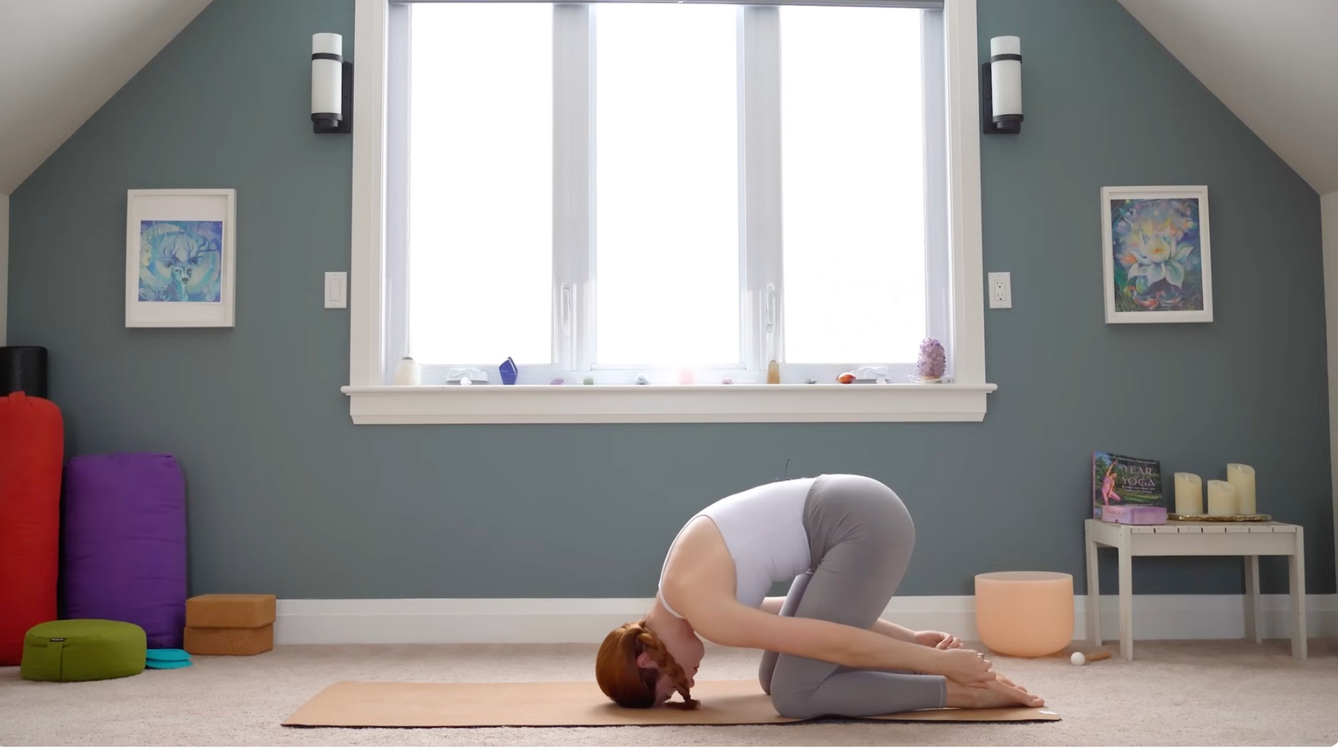 Woman kneeling with her head on the mat in Rabbit Pose