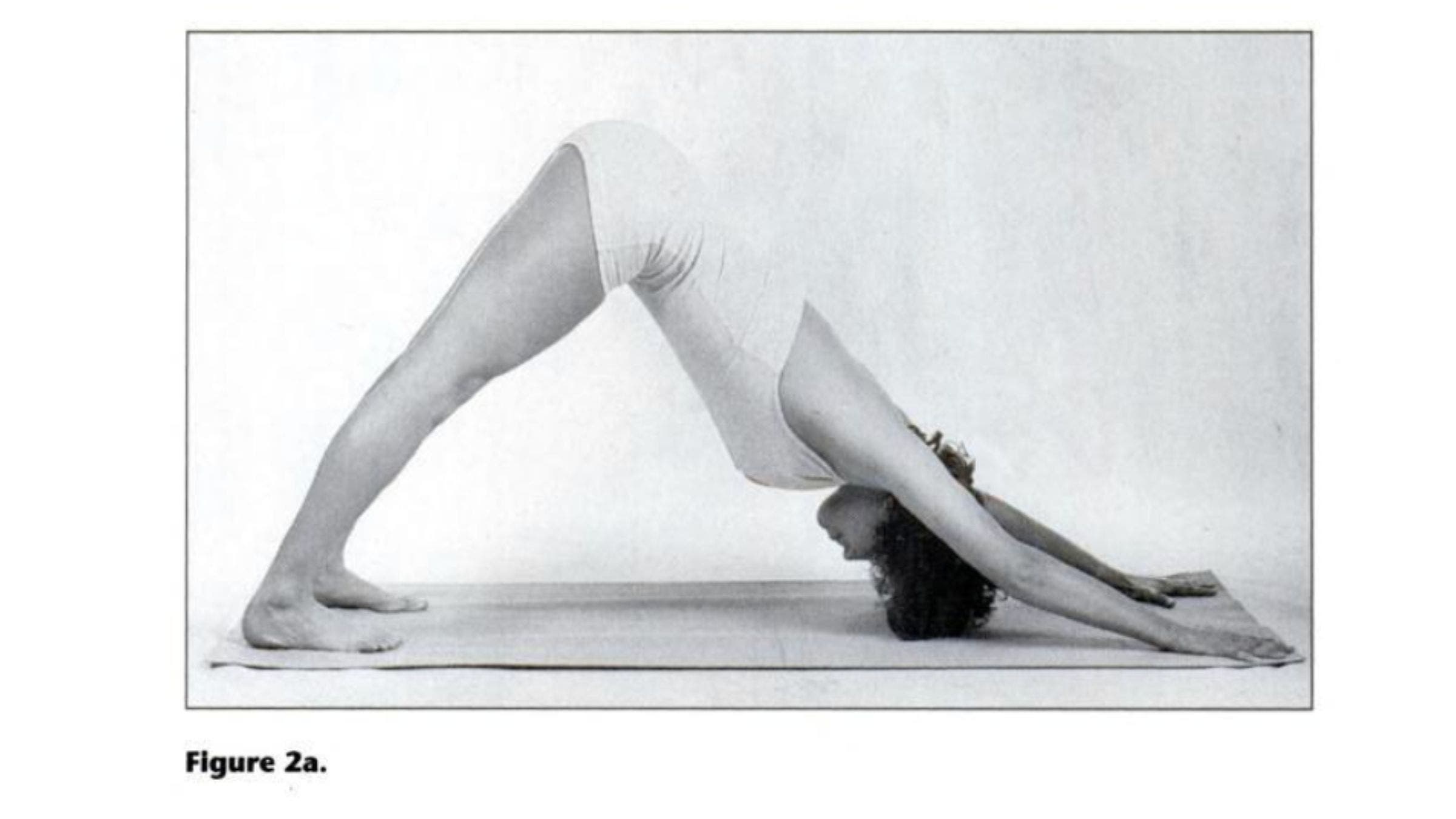 Woman practicing Down Dog for tight shoulders.