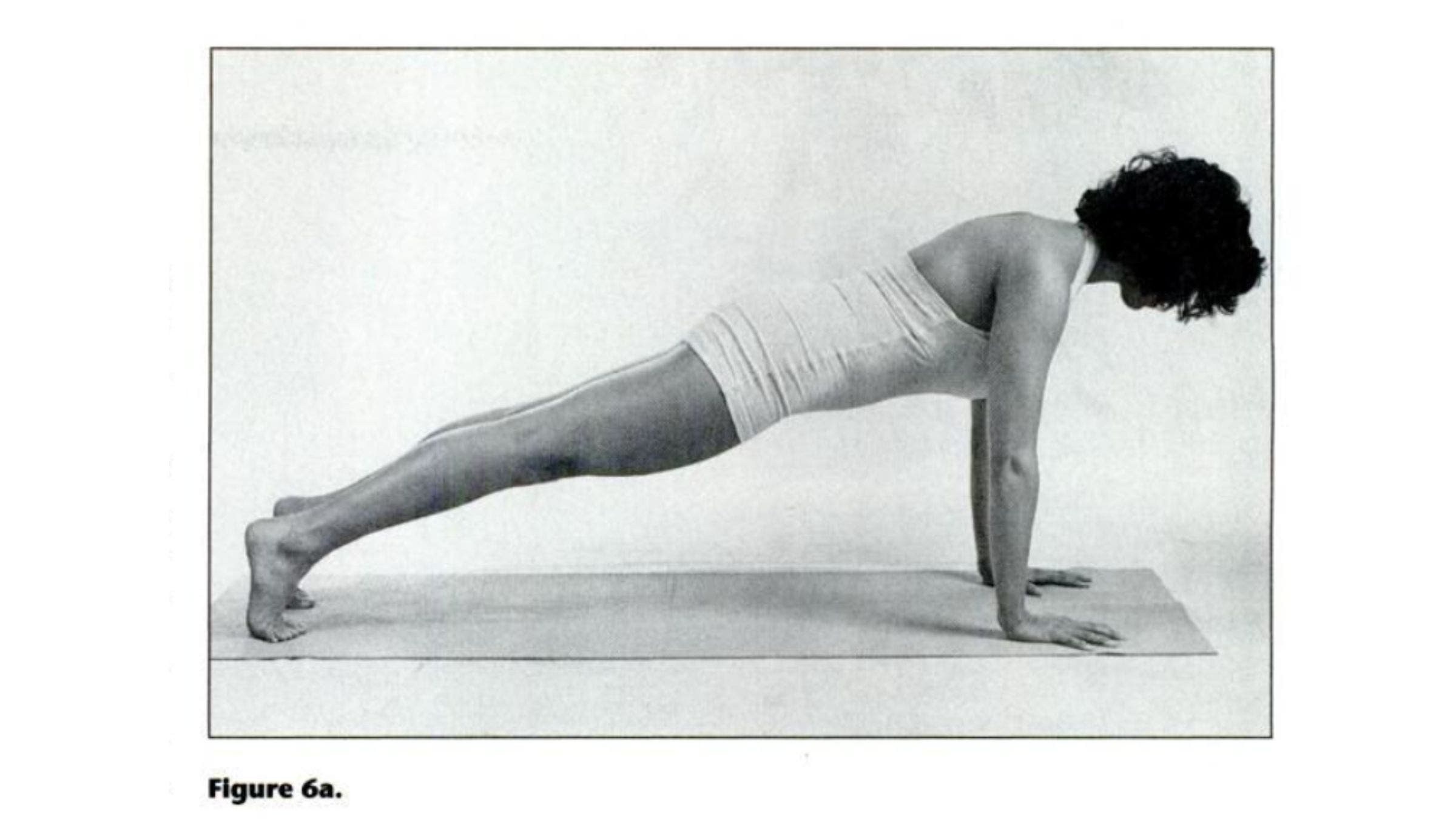 Woman practicing Plank Pose for tight shoulders.