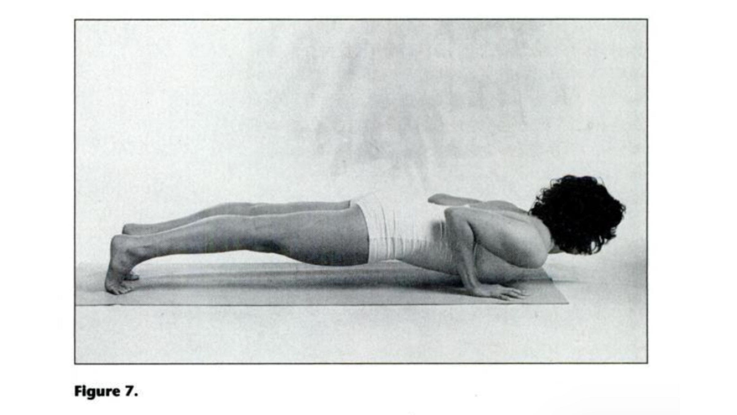 Woman practicing Rod Pose for tight shoulders.