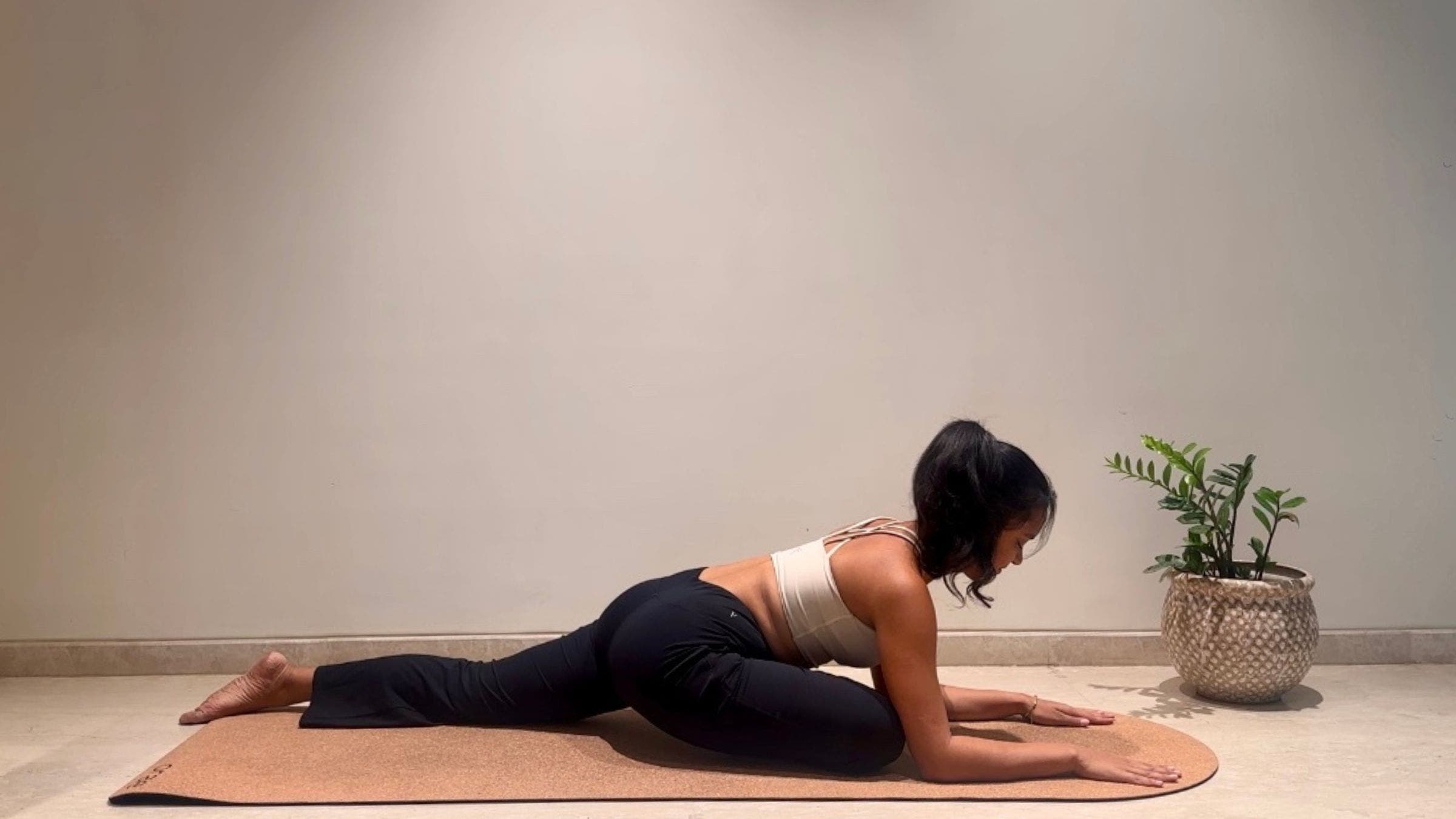 Yoga instruction doing Pigeon Pose