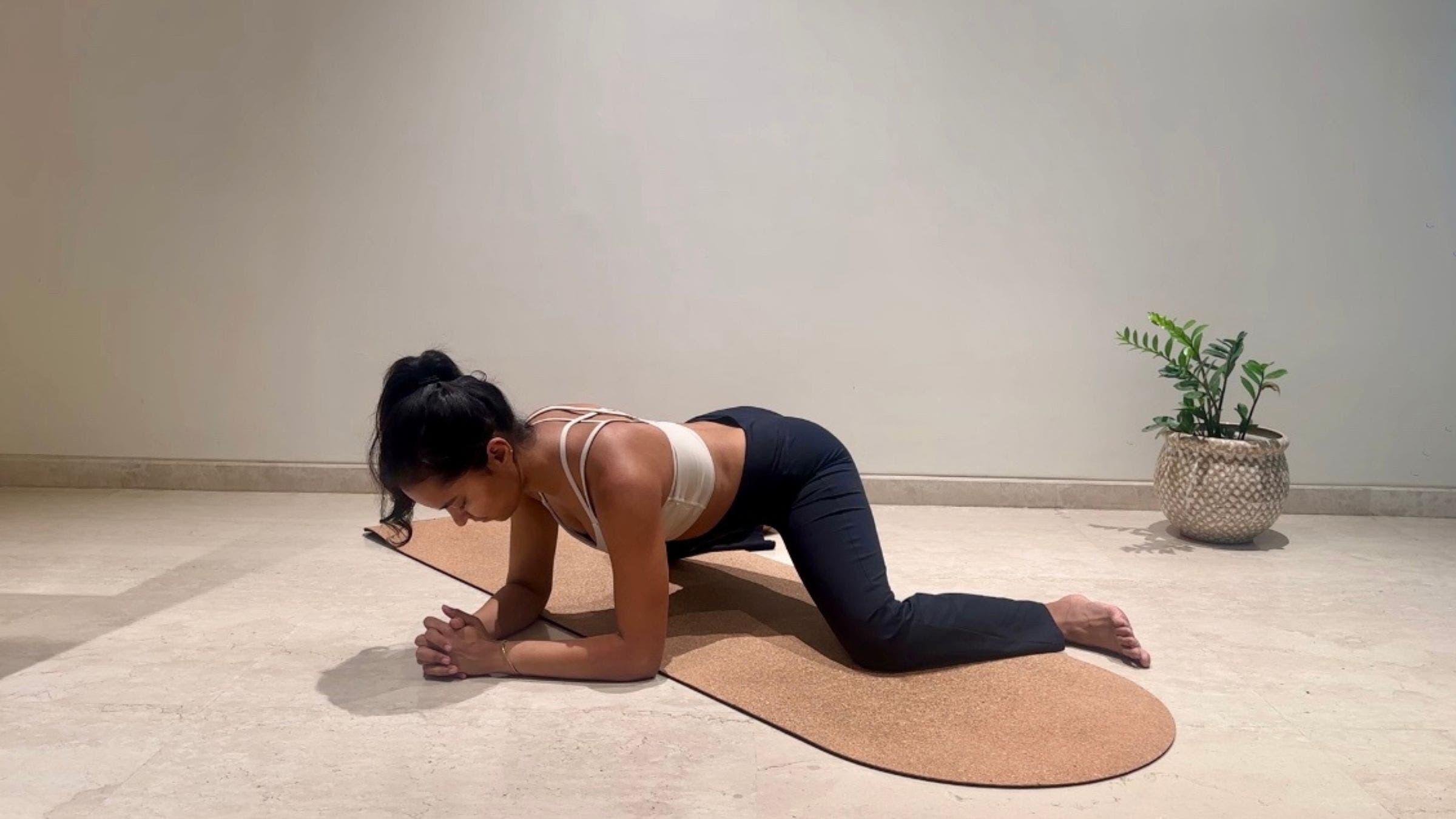 Yoga instructor doing Frog Pose.