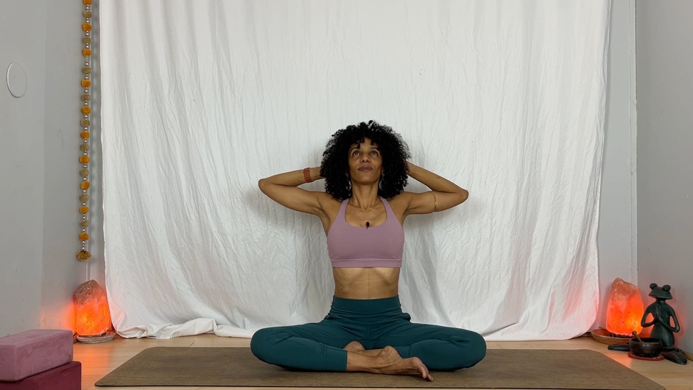 Yoga instructor practicing seated cow pose.