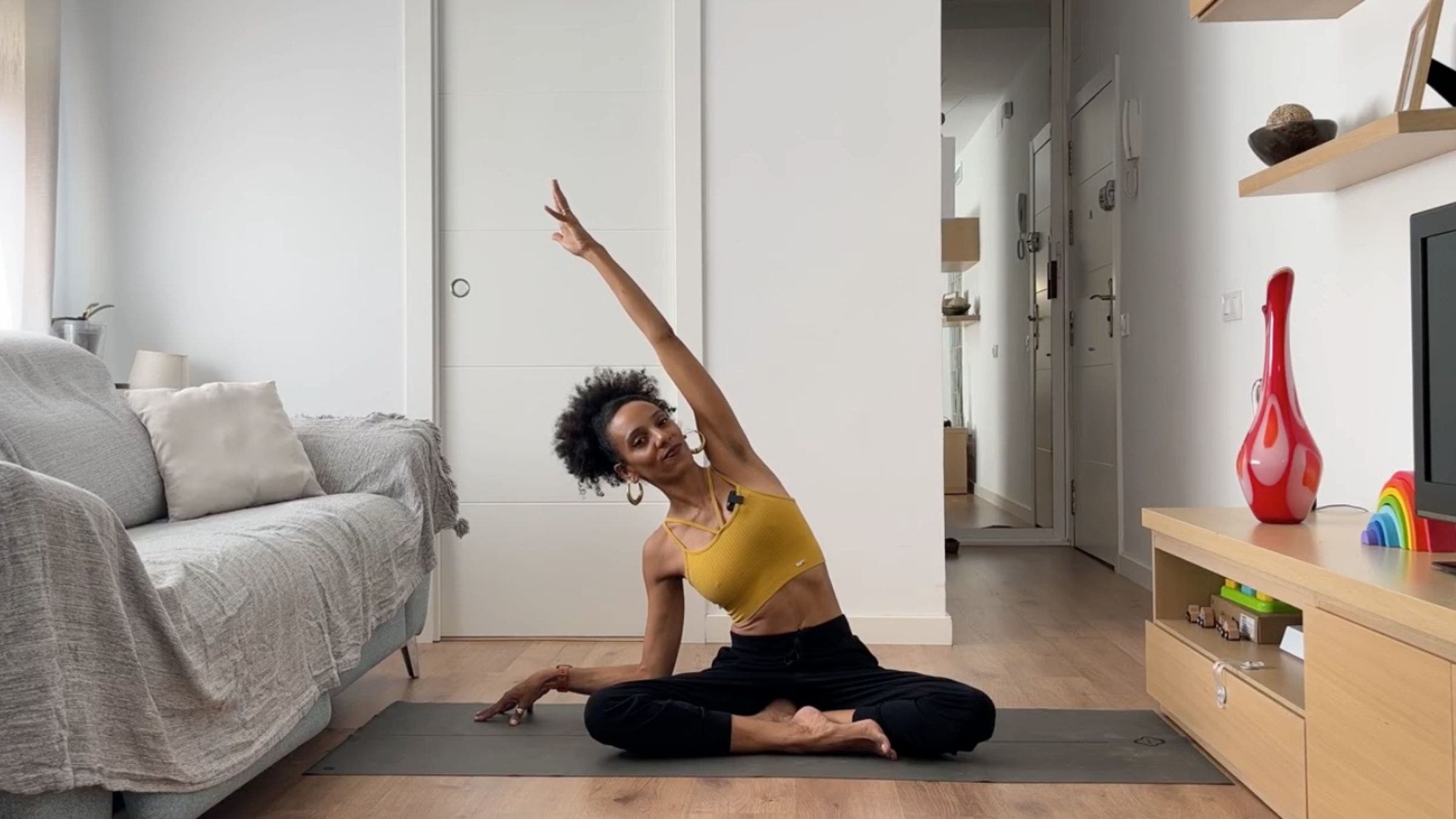 Woman practicing seated side stretch.