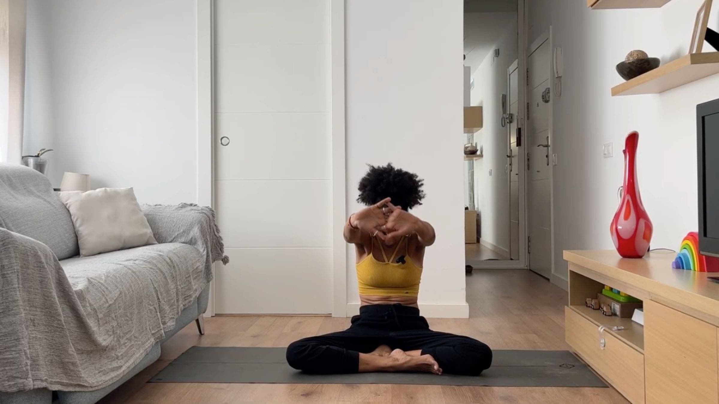 Woman practicing Cat Pose variation.