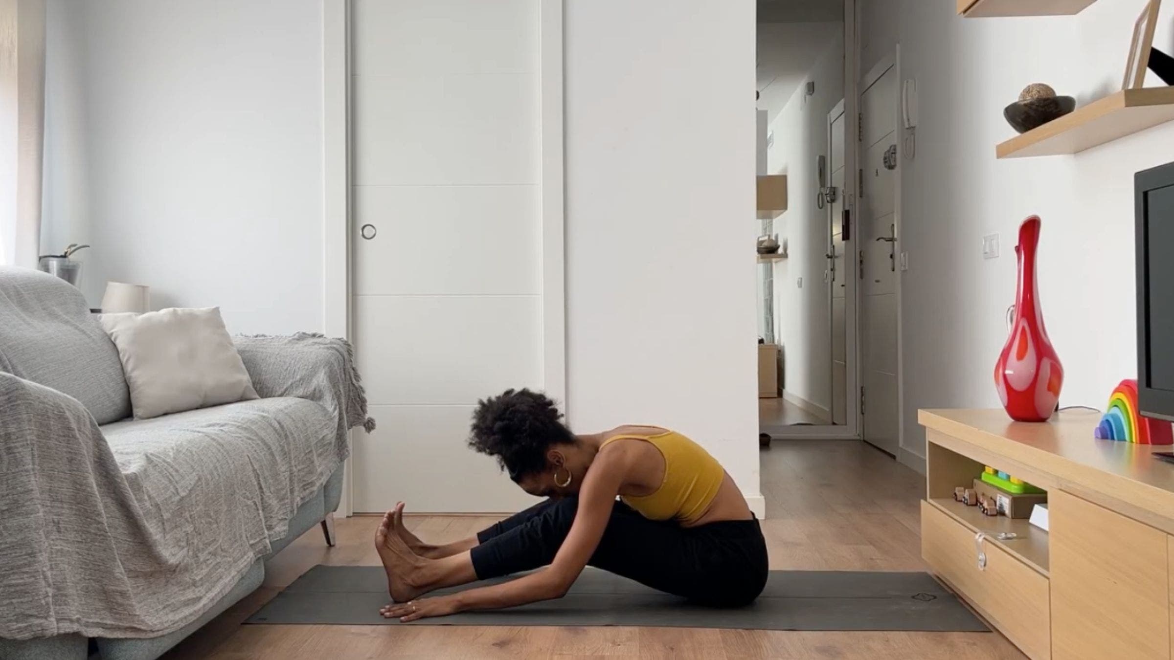 Woman practicing seated forward fold.