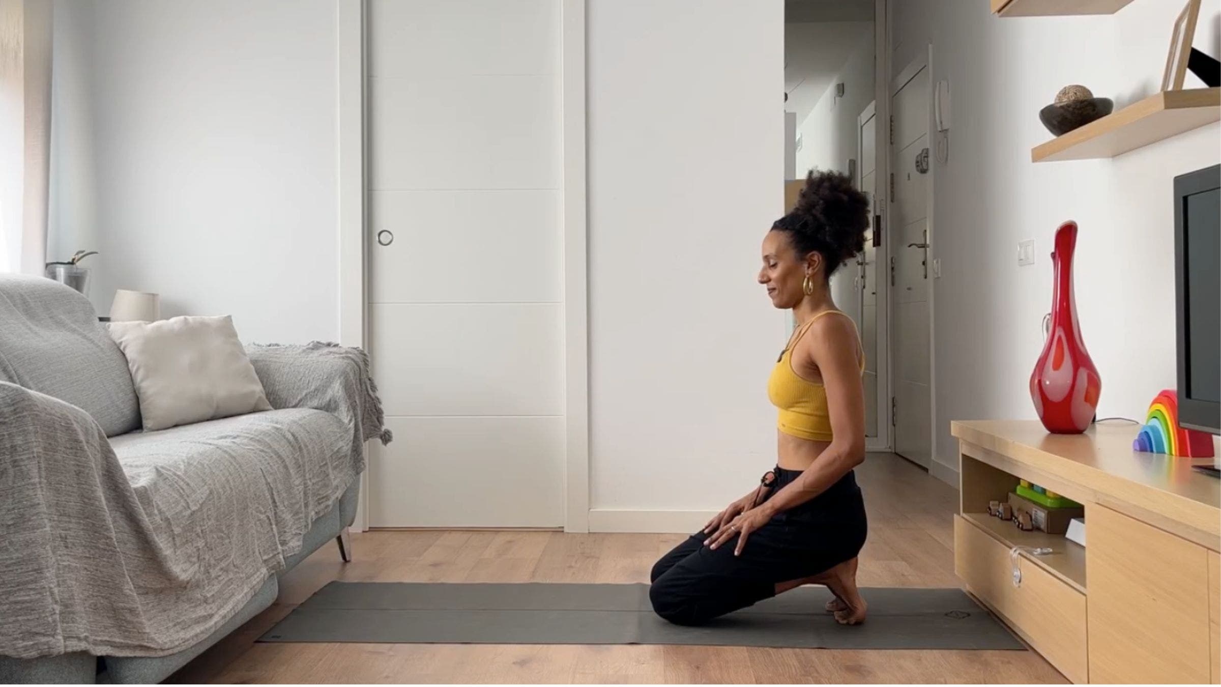Woman practicing Toe Squat variation.