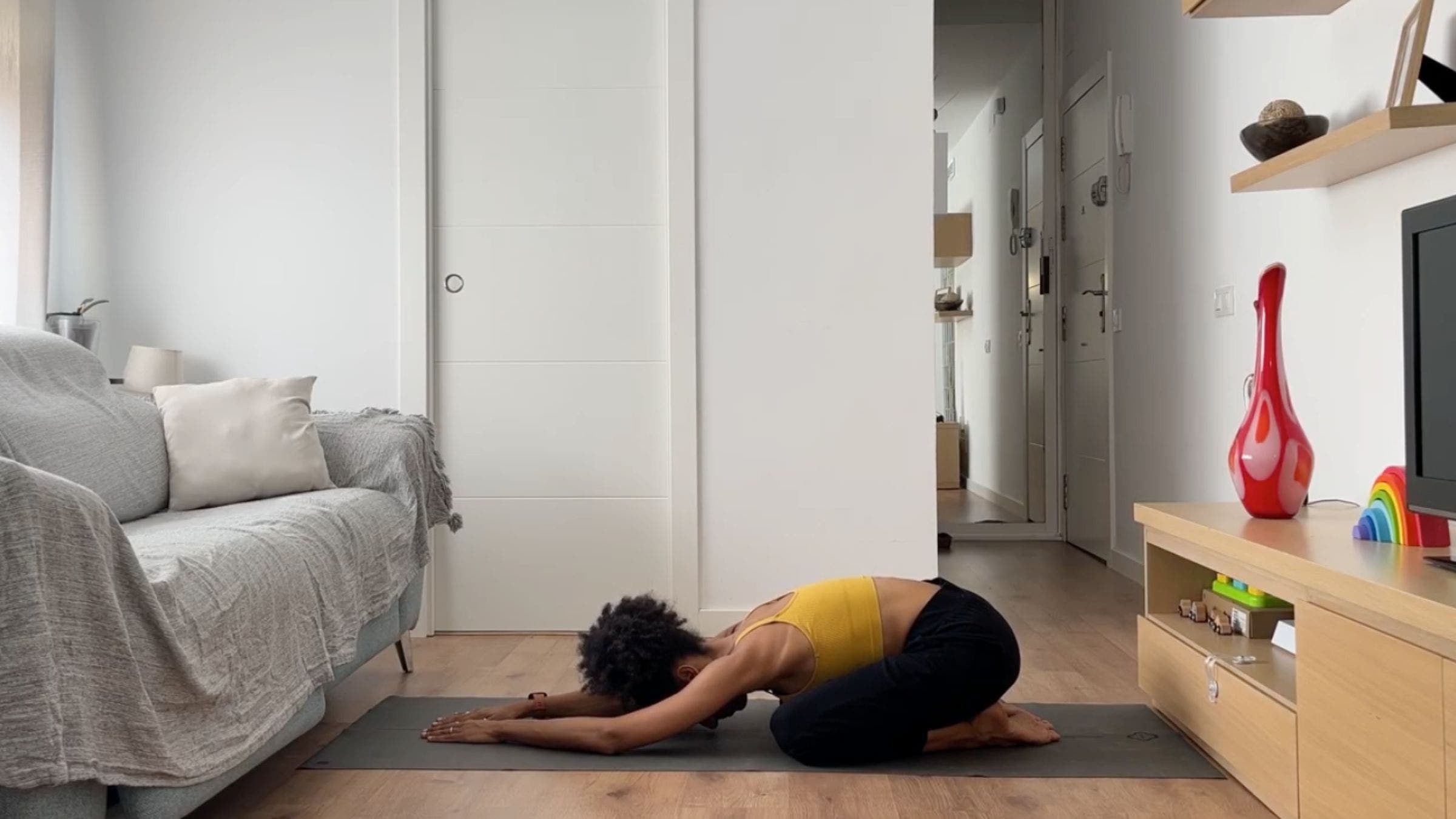 Woman practicing Child's Pose.