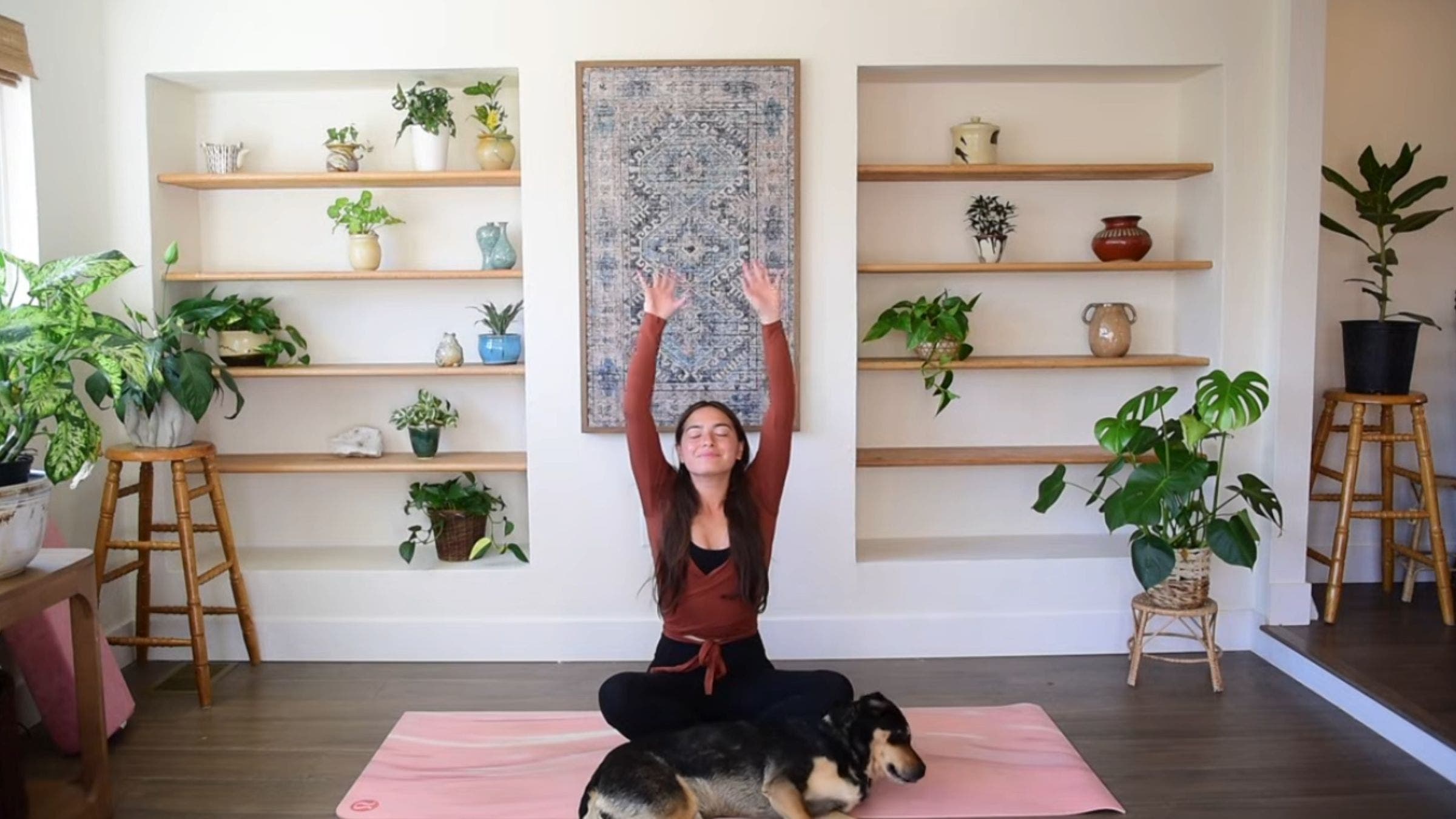 Yoga instructor Caitlin K'eli practicing seated arm stretch.