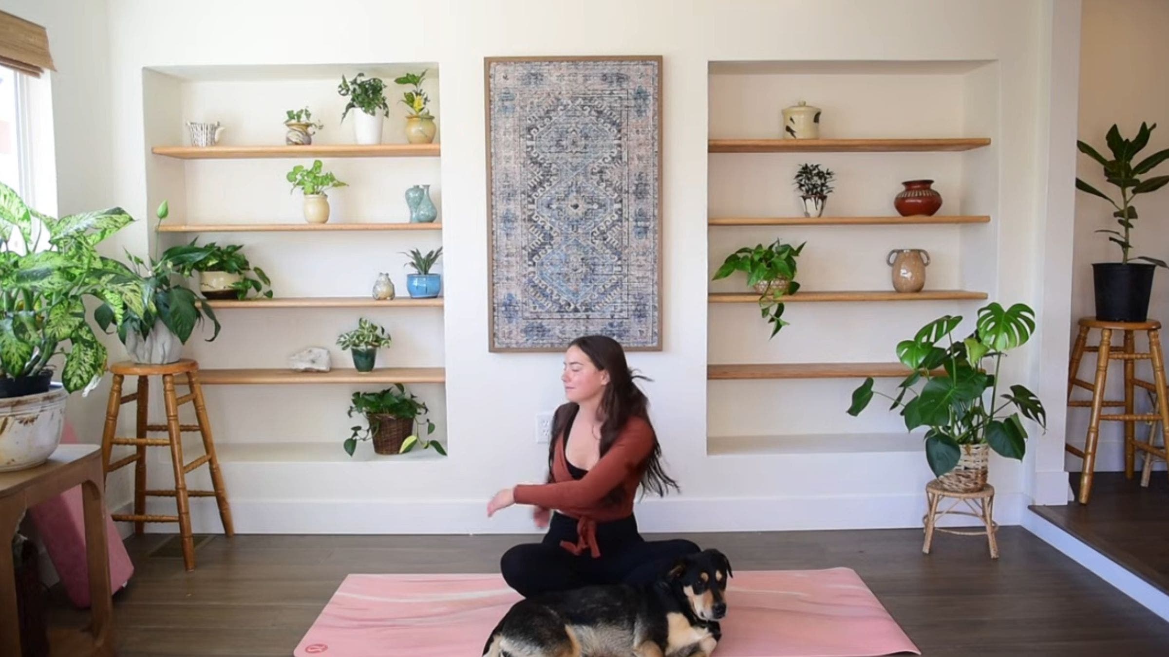 Yoga instructor Caitlin K'eli practicing seated arm swings.