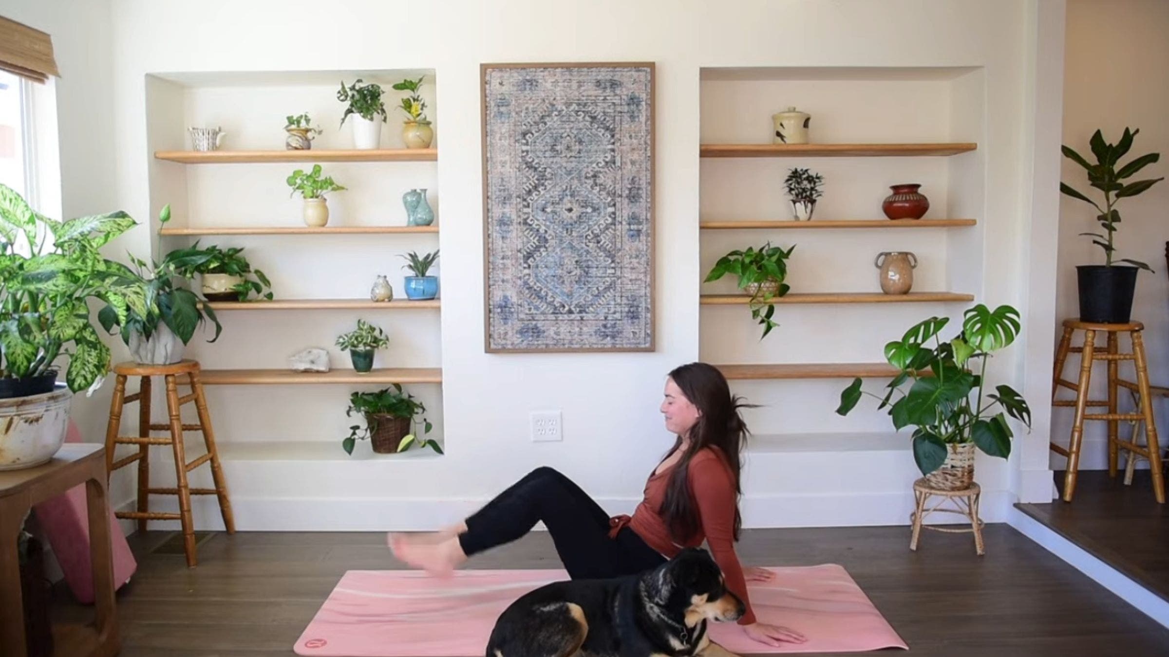 Yoga instructor Caitlin K'eli practicing seated foot taps.