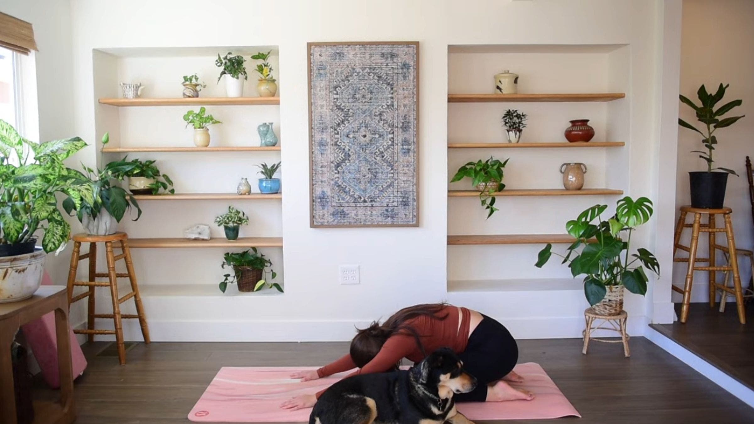 Yoga instructor Caitlin K'eli practicing Child's Pose.