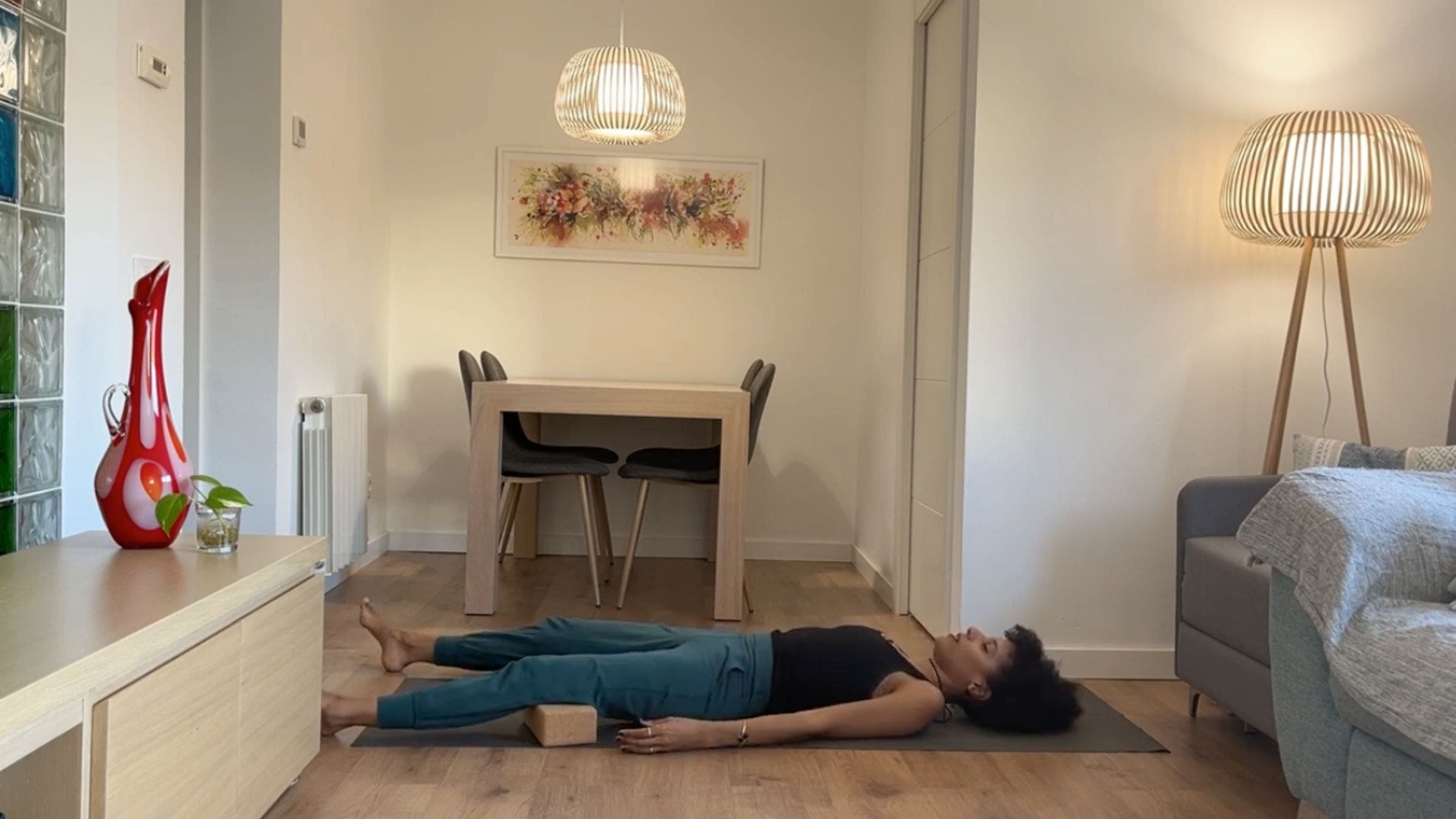 Yoga instructor practicing Savasana.