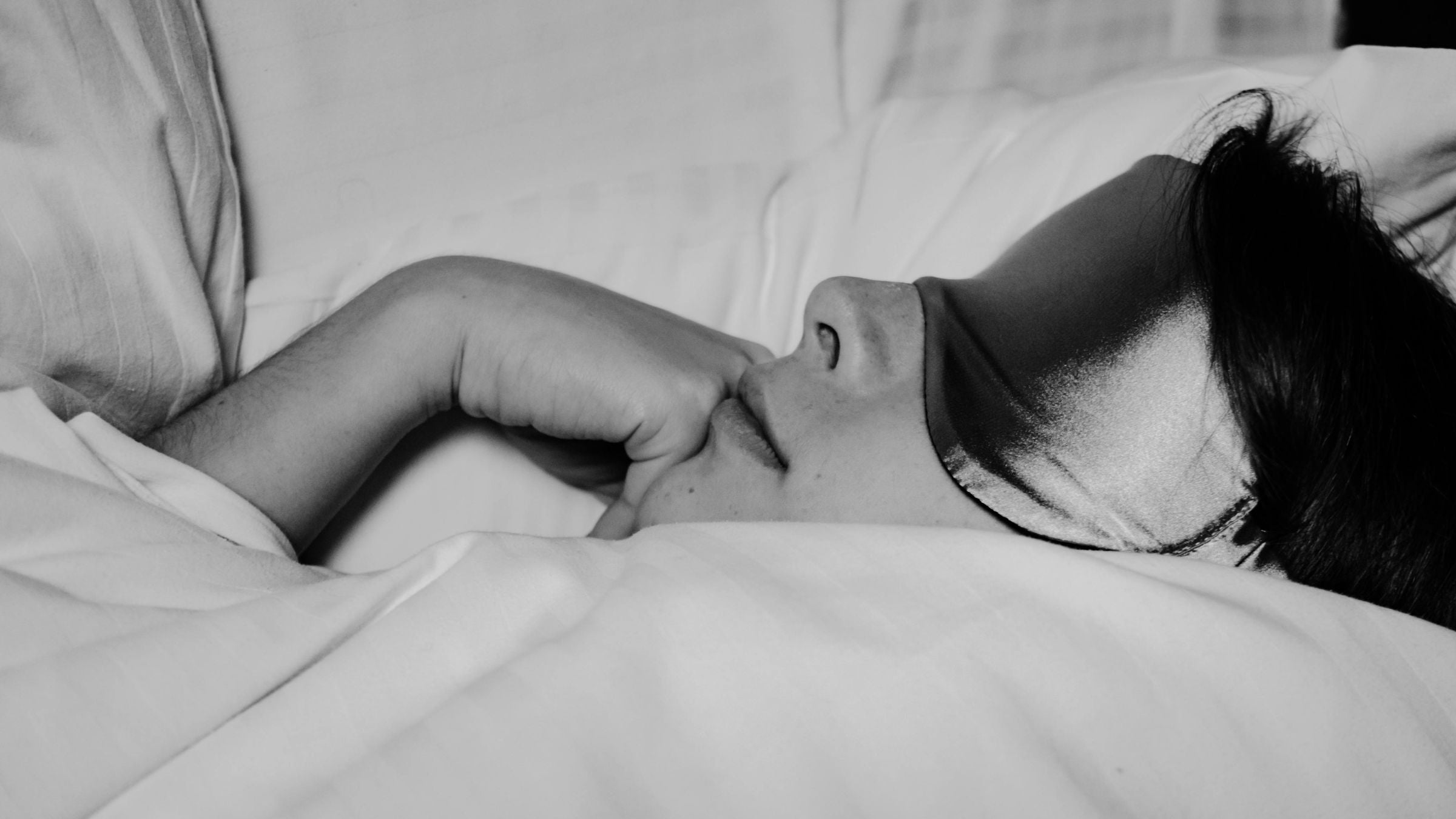 Woman resting in bed after doing yoga for sleep.