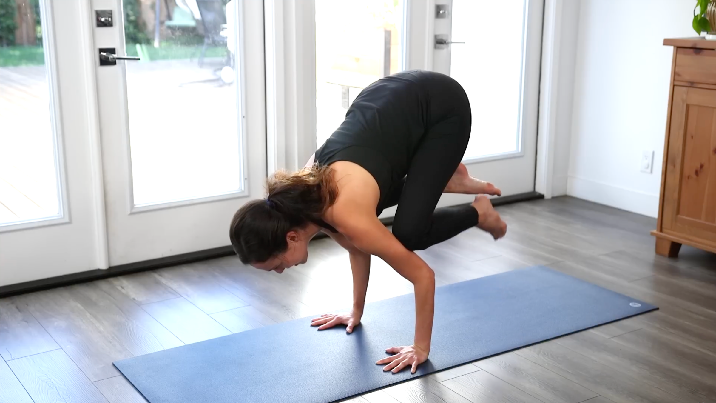 Yoga with Adrian in Crow Pose, one of the most popular arm balances