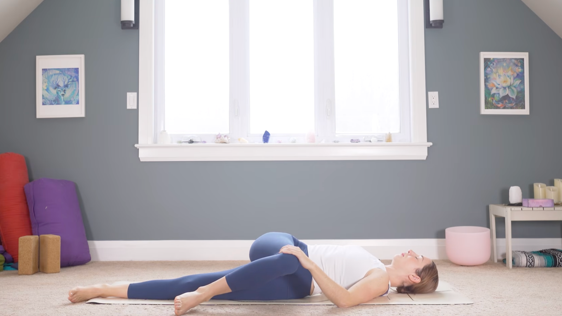 Woman lying on her back with one knee crossed over to the opposite side