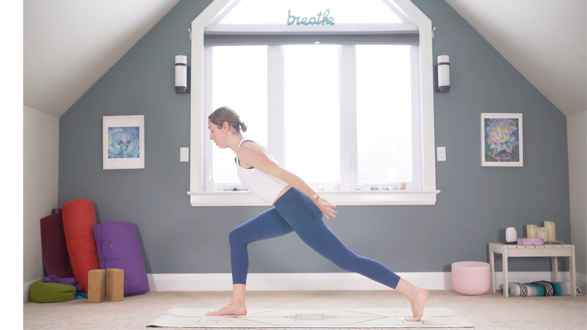 Woman leaning forward in High Lunge with her arms alongside her body