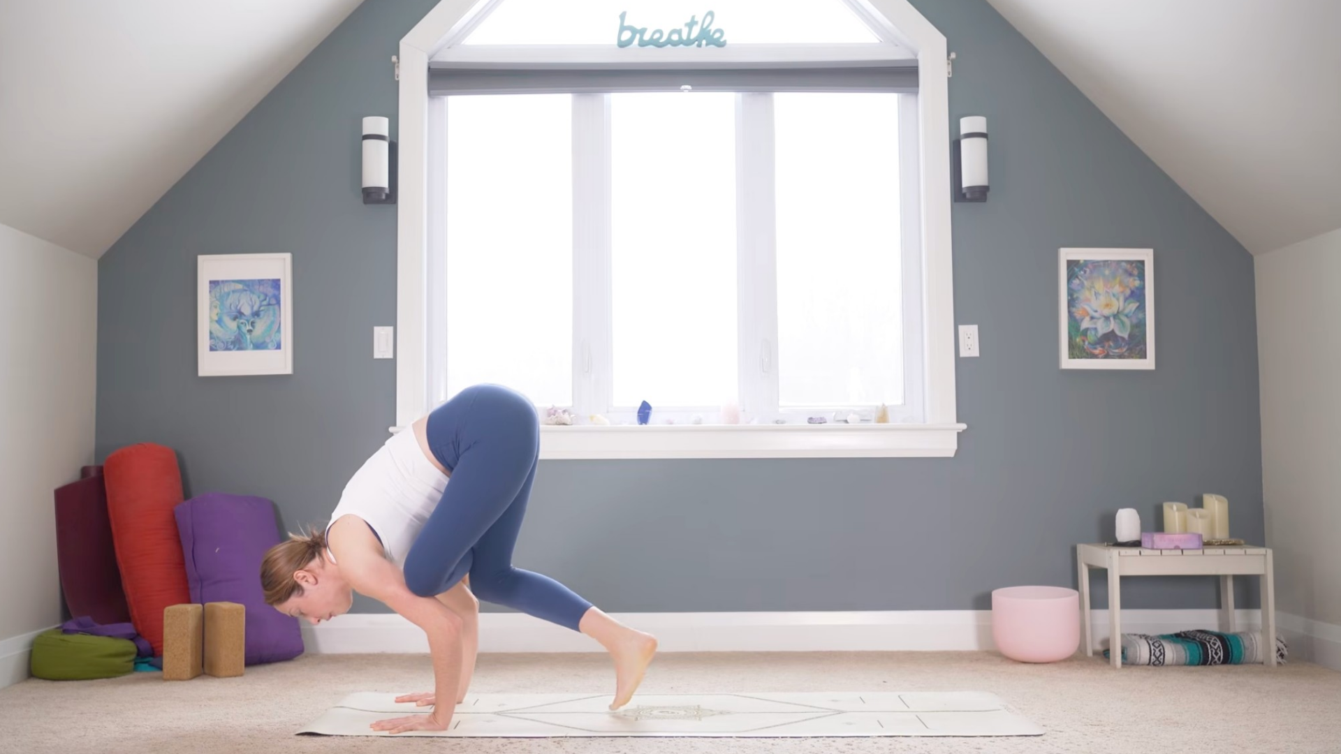 Woman leaning forward on her hands as she preps for Flying Pigeon Pose