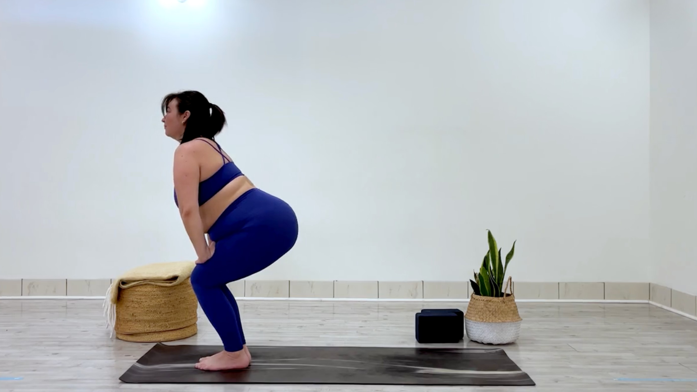 Yoga teacher Taylor Lorenz in chair pose