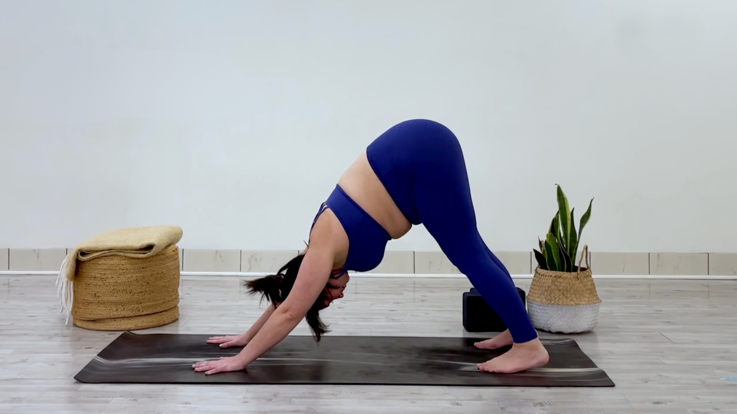 Yoga teacher Taylor Lorenz in Downward-Facing Dog