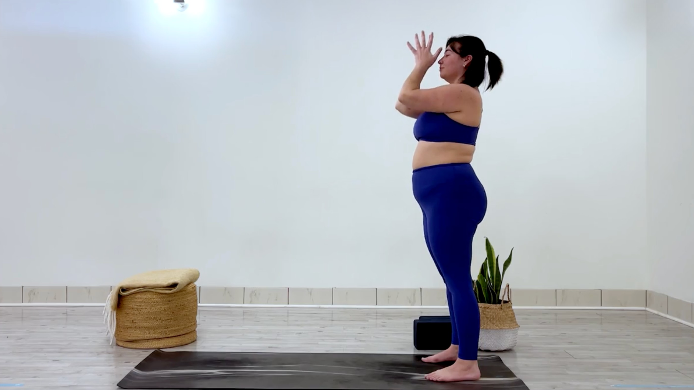 Yoga teacher Taylor Lorenz poses in mountain pose, which is part of her yoga practice when she feels overstimulated