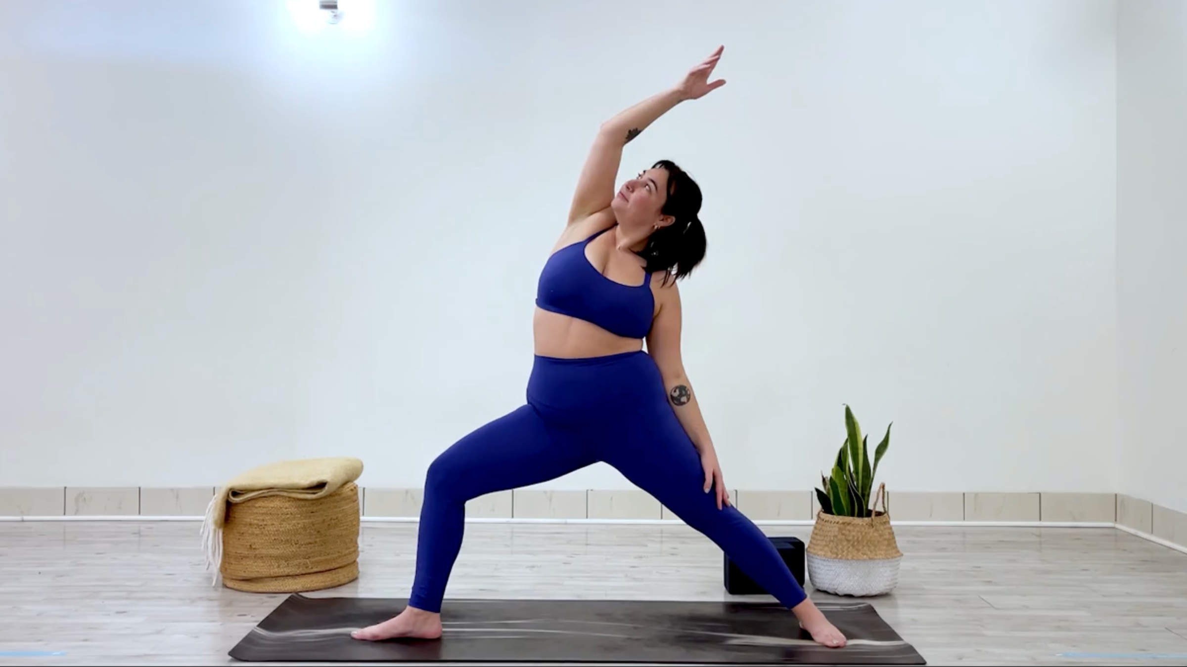 Yoga teacher Taylor Lorenz in Reverse Warrior, part of her yoga practice when she's feeling overstimulated