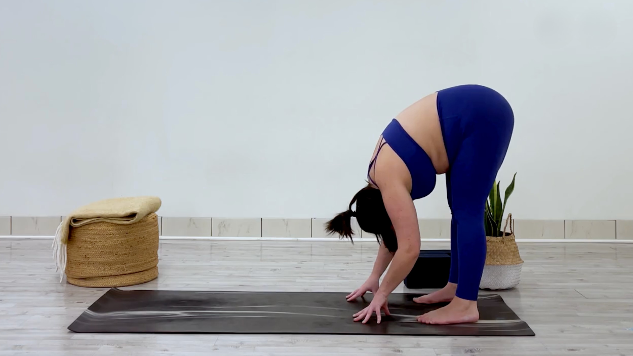 Yoga teacher Taylor Lorenz at Standing Forward Bend, part of her yoga practice when she's feeling overstimulated