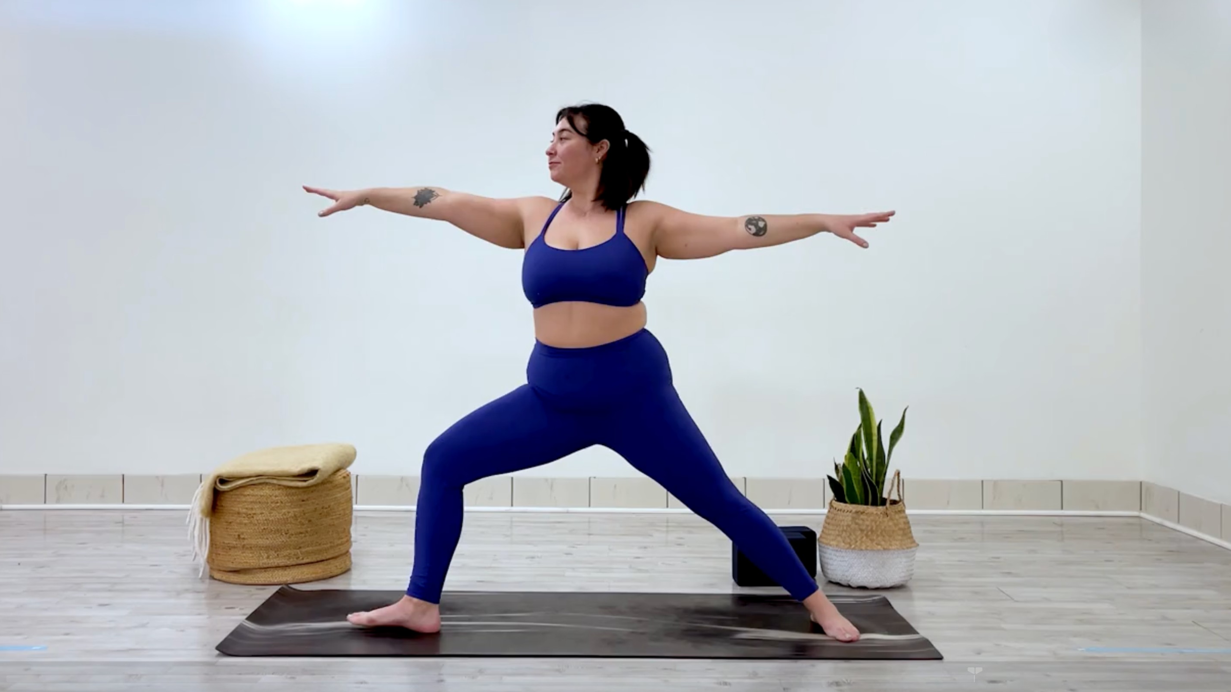 Yoga teacher Taylor Lorenz at Warrior 2, part of her yoga practice when she's feeling overstimulated