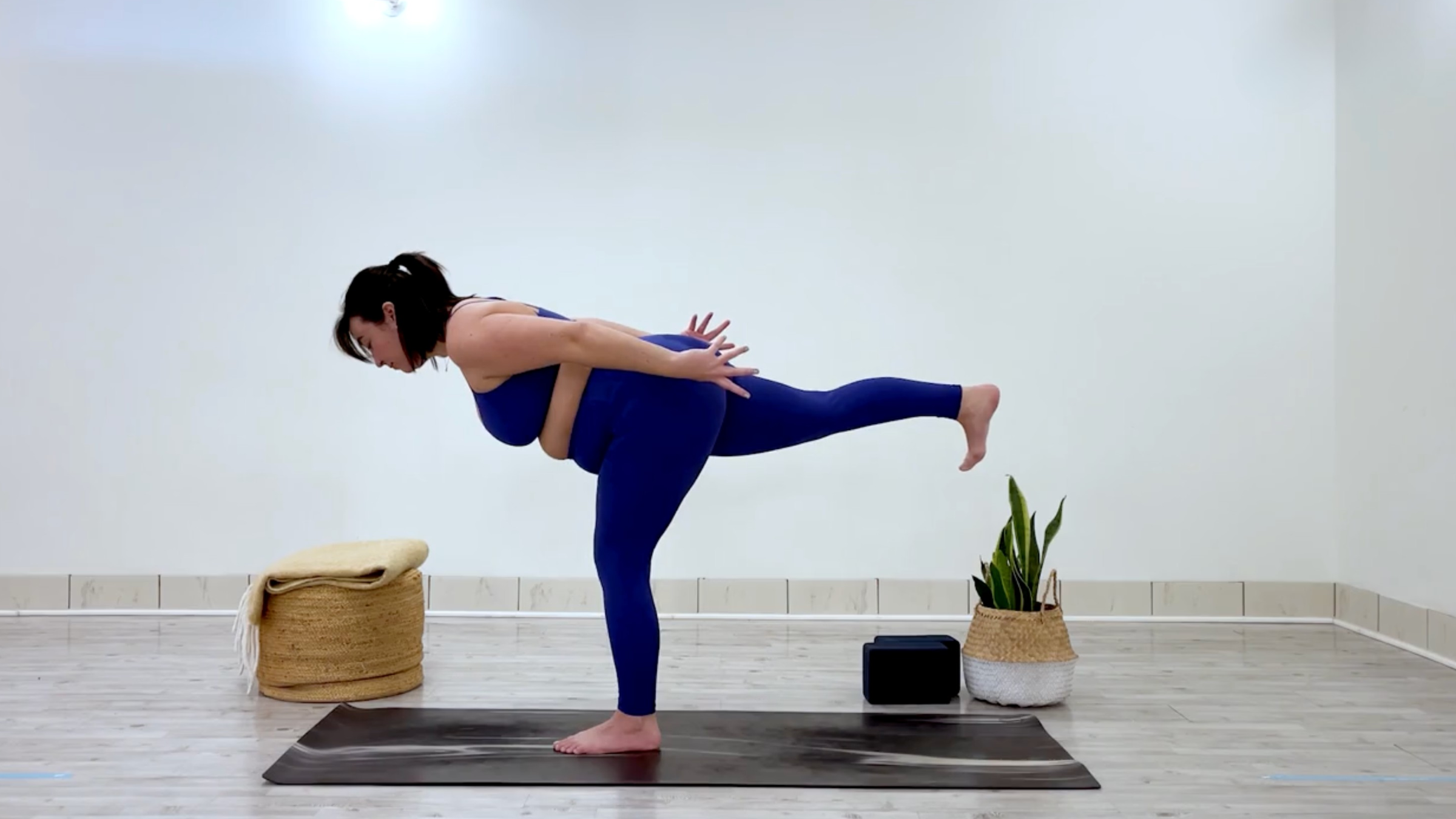 Yoga teacher Taylor Lorenz at Warrior 3, part of her yoga practice when she's feeling overstimulated