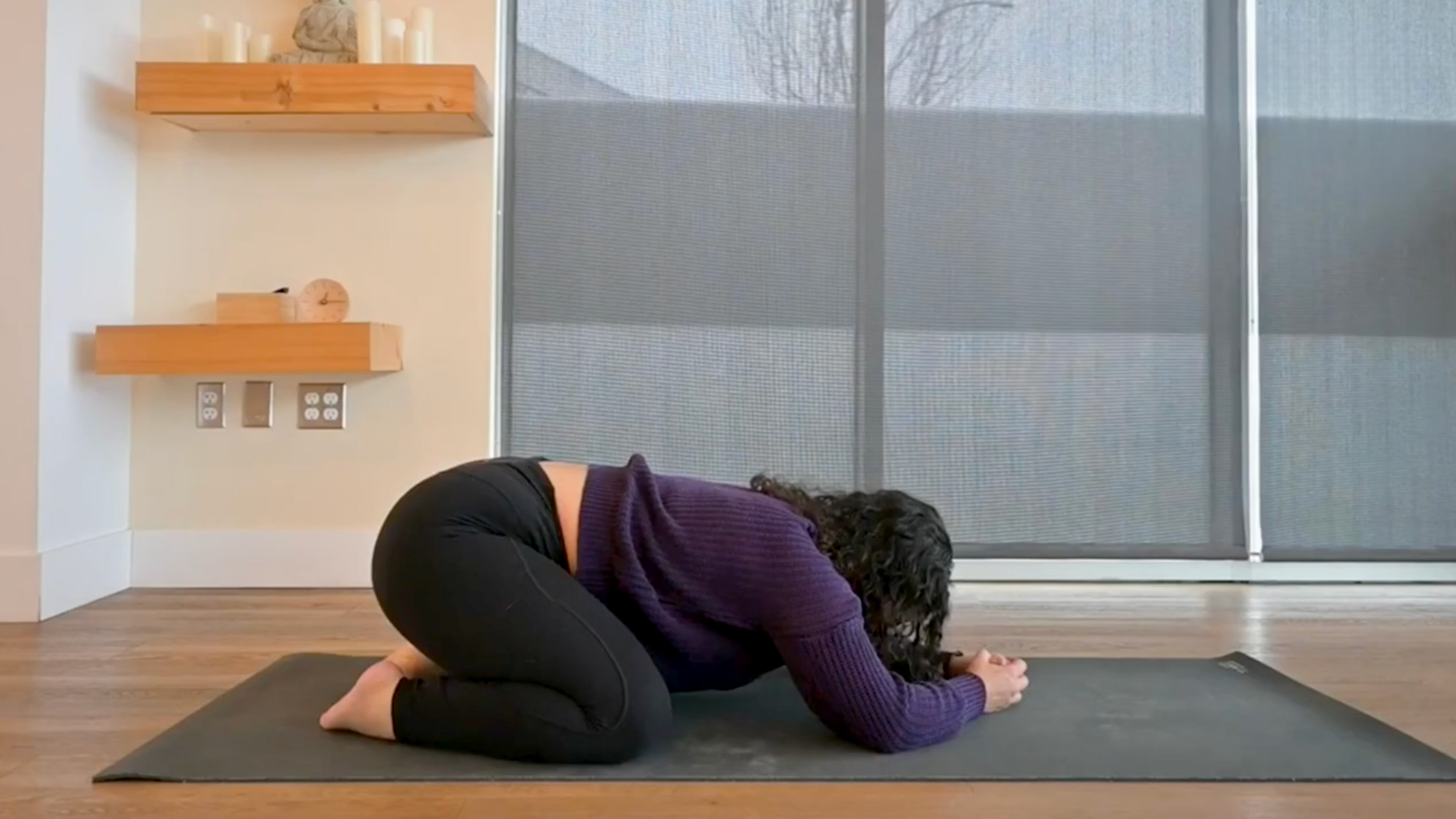 Yoga teacher Audriana Monteiro in Child's Pose, part of her positive affirmations yoga practice