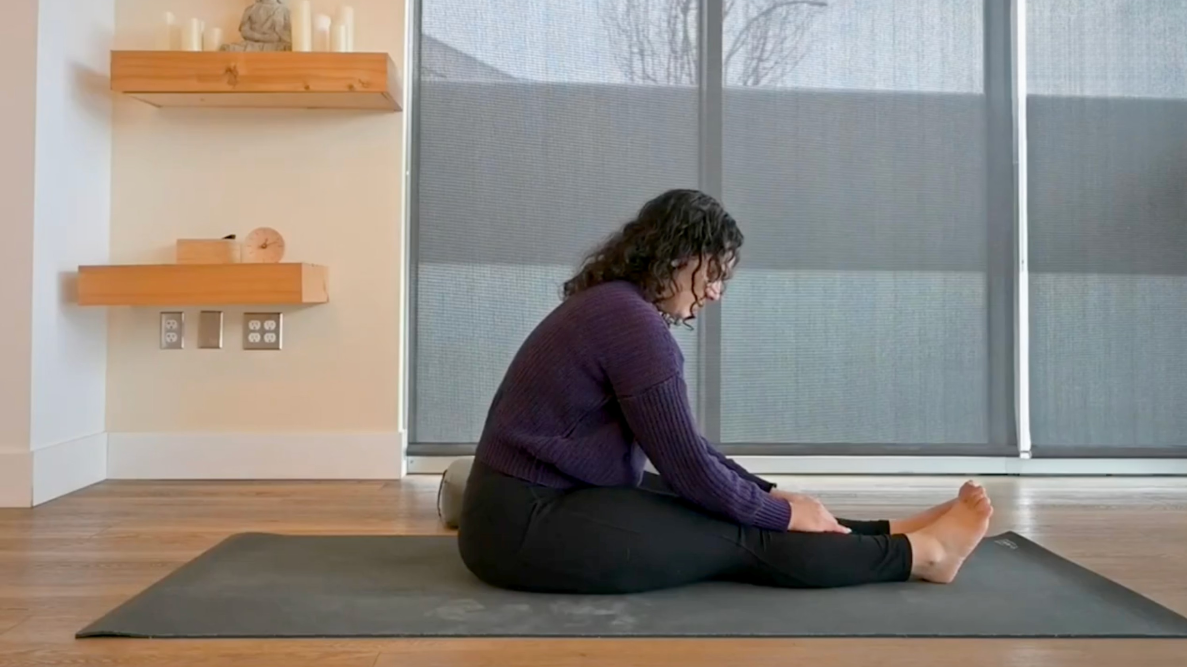 Yoga teacher Audriana Monteiro in Seated Forward Bend, part of her positive affirmations yoga practice