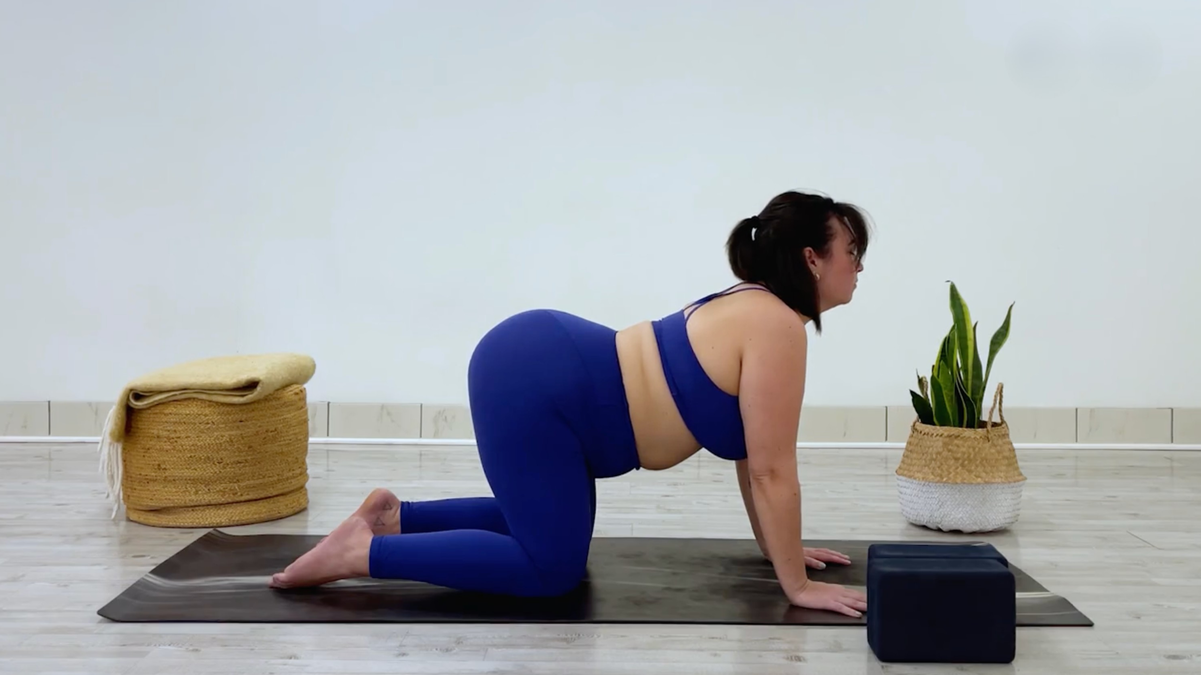 Yoga teacher Taylor Lorenz in cow pose, a yin yoga pose to stretch her inner thighs