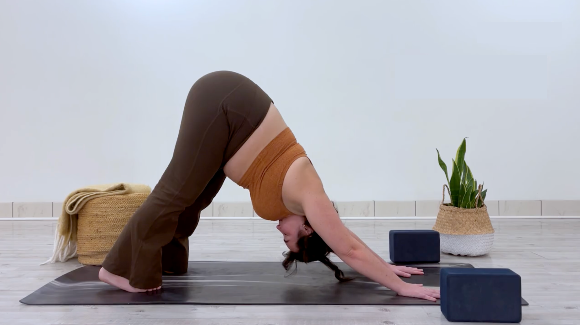 Yoga teacher Taylor Lorenz in Downward-Facing Dog, part of her yin yoga for energy practice