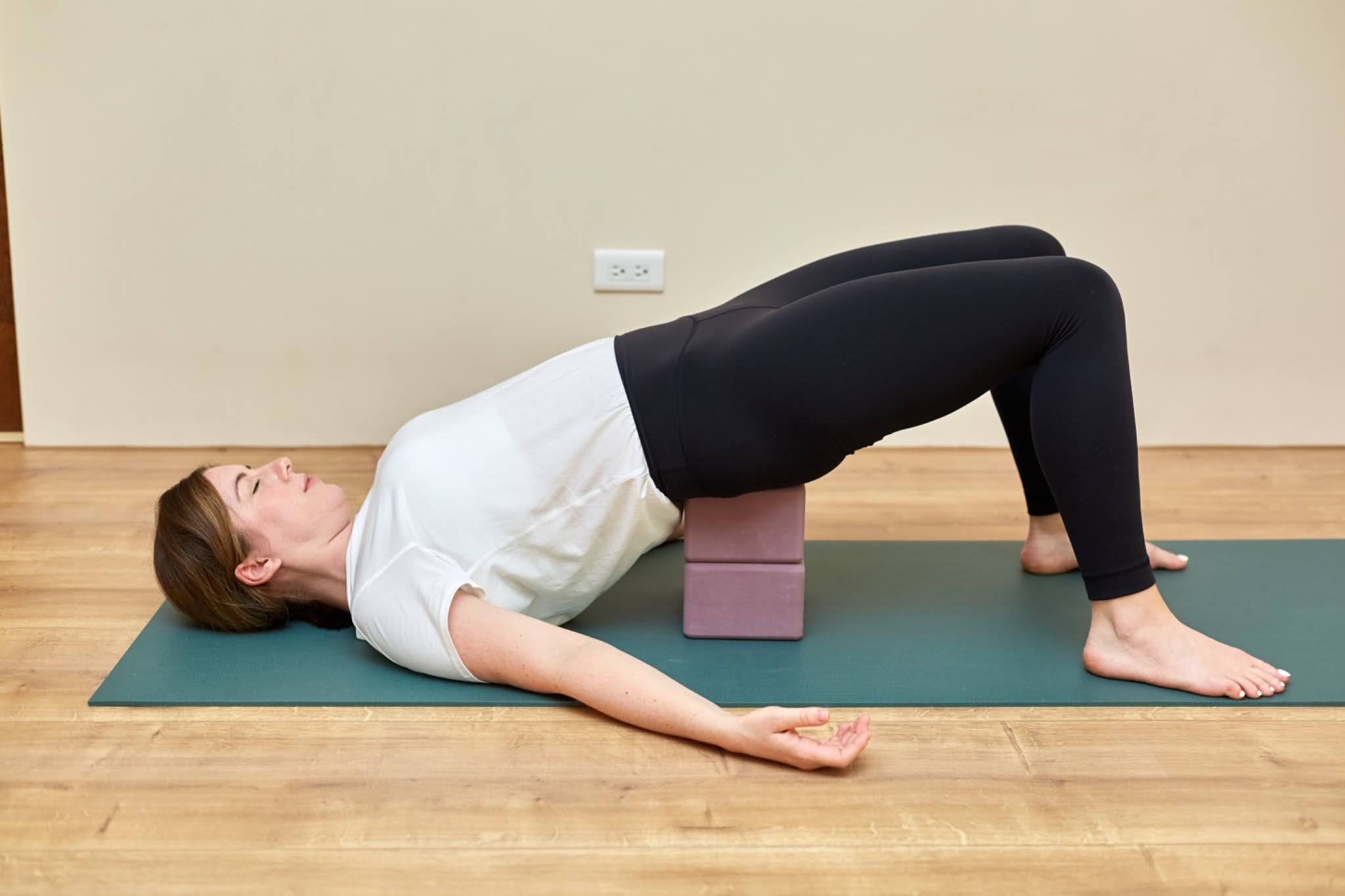 Yoga teacher Katie McGrath in Supported Bridge Pose