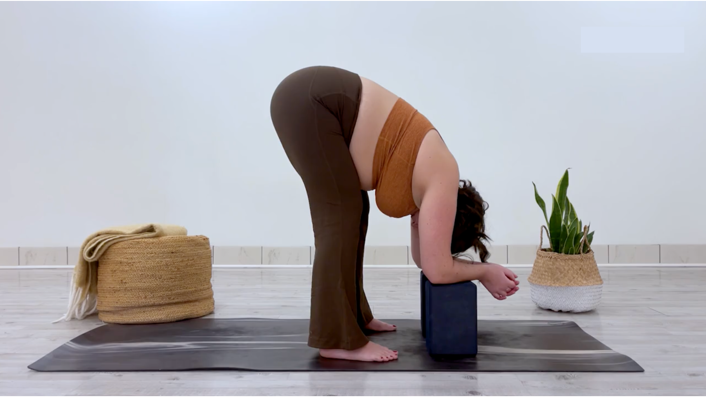 Teacher Taylor Lorenz in Standing Forward Bend