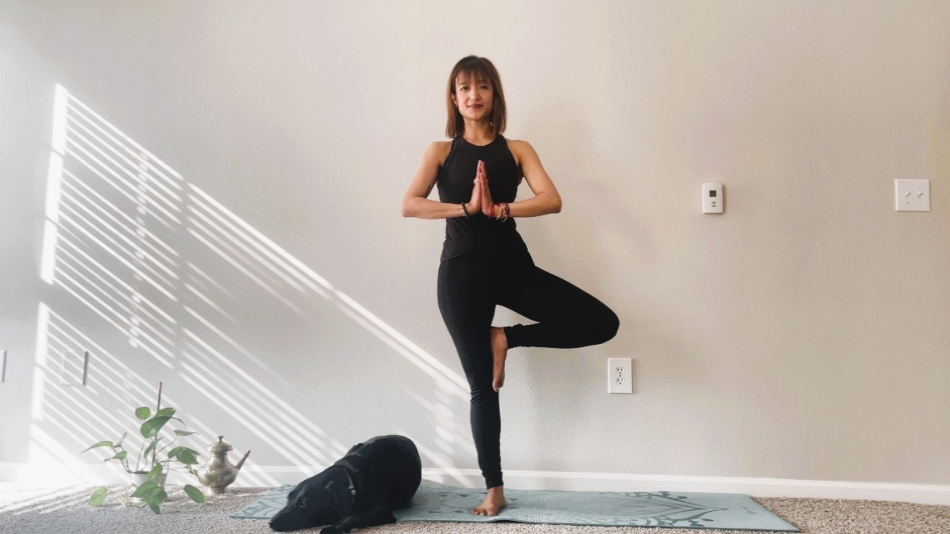 Woman balancing on one leg in Tree Pose