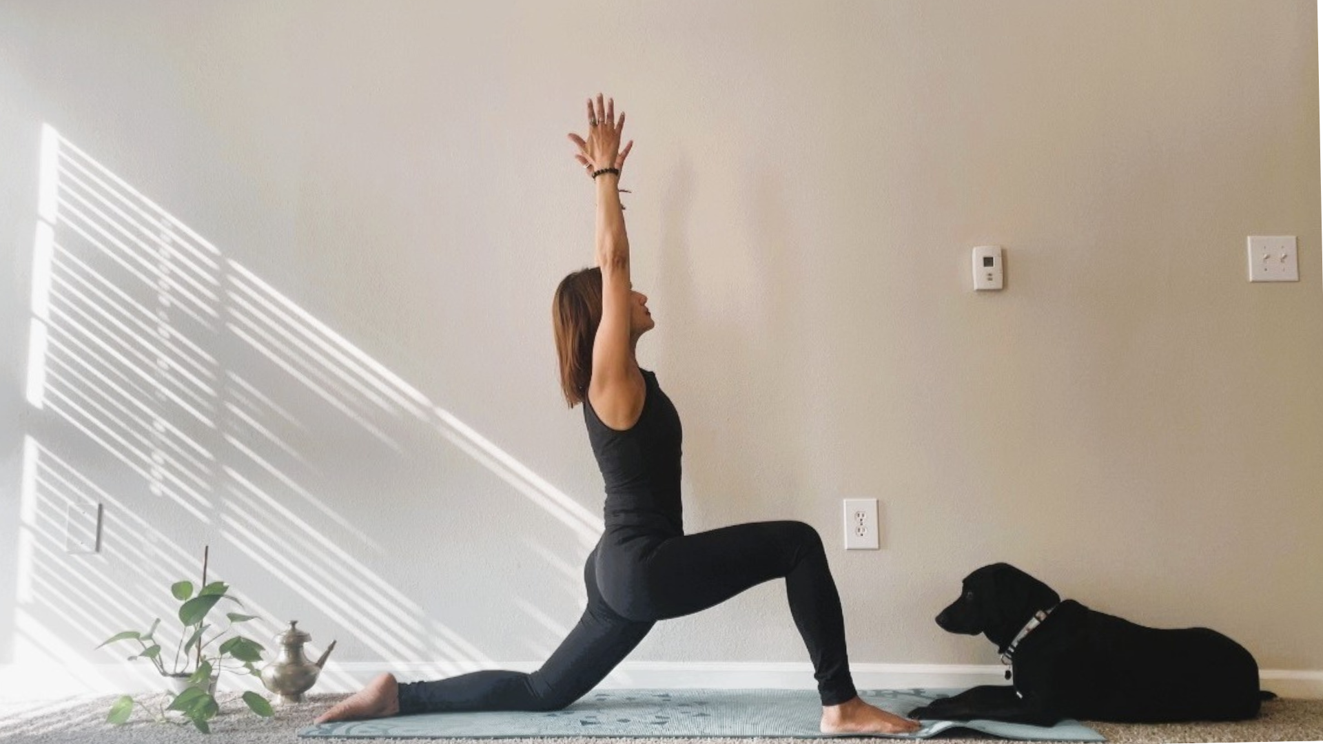 Woman kneeling on a yoga mat in Low Lunge