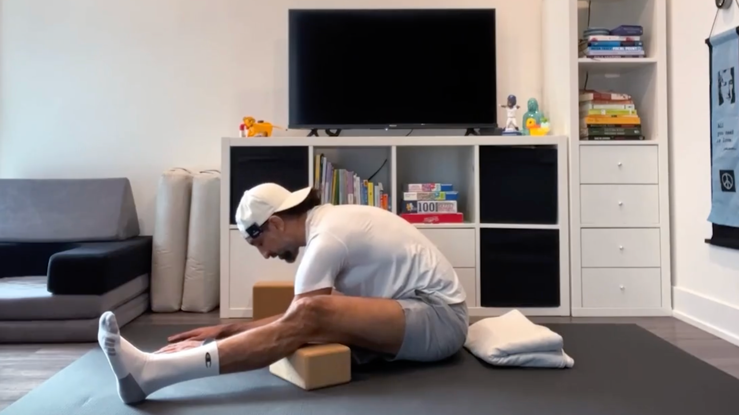 Yoga teacher Jaafar Hussain poses in a wide-angle forward bend pose, part of his yoga exercises for the hips