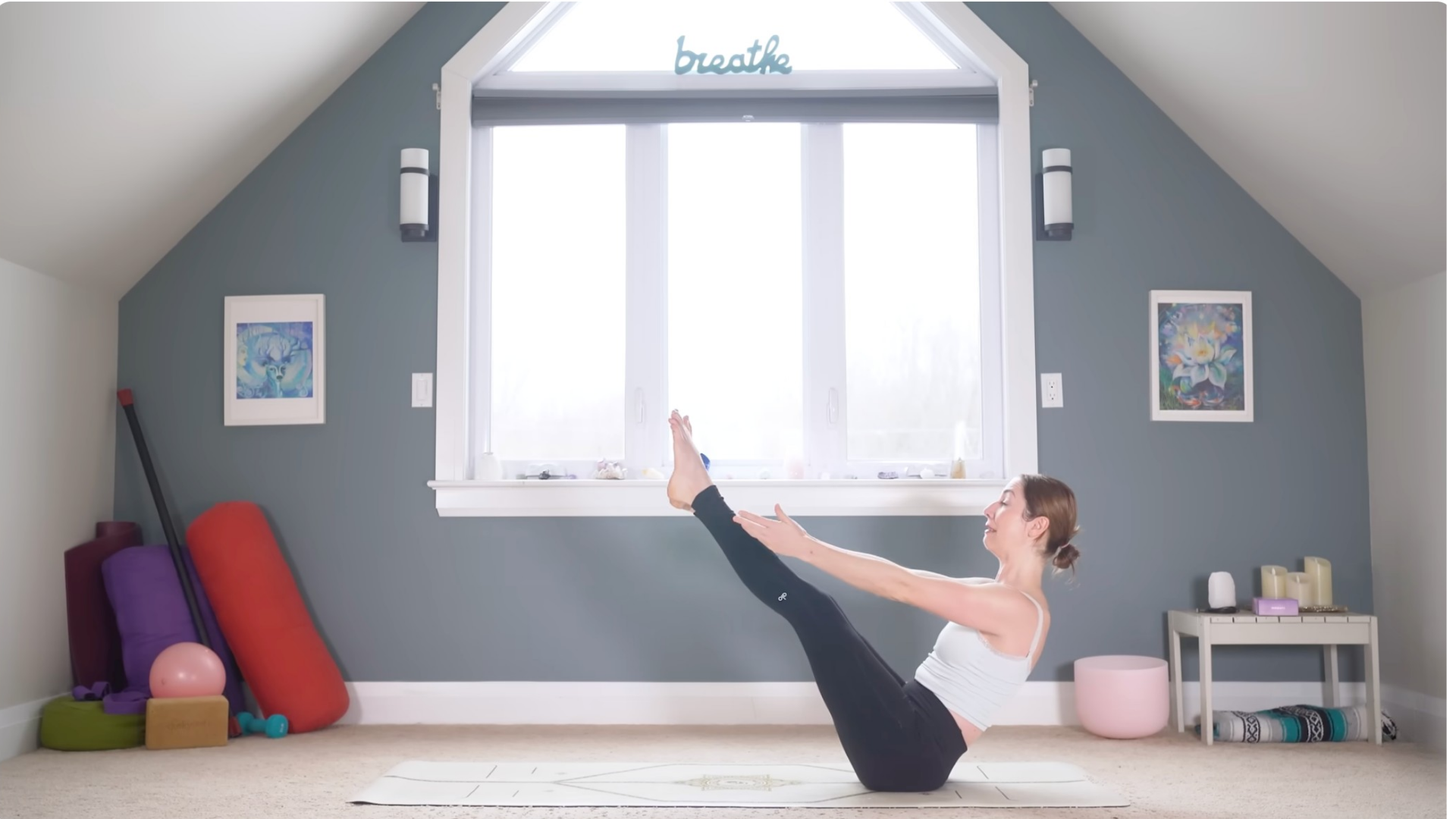 Woman in Boat Pose on a yoga mat