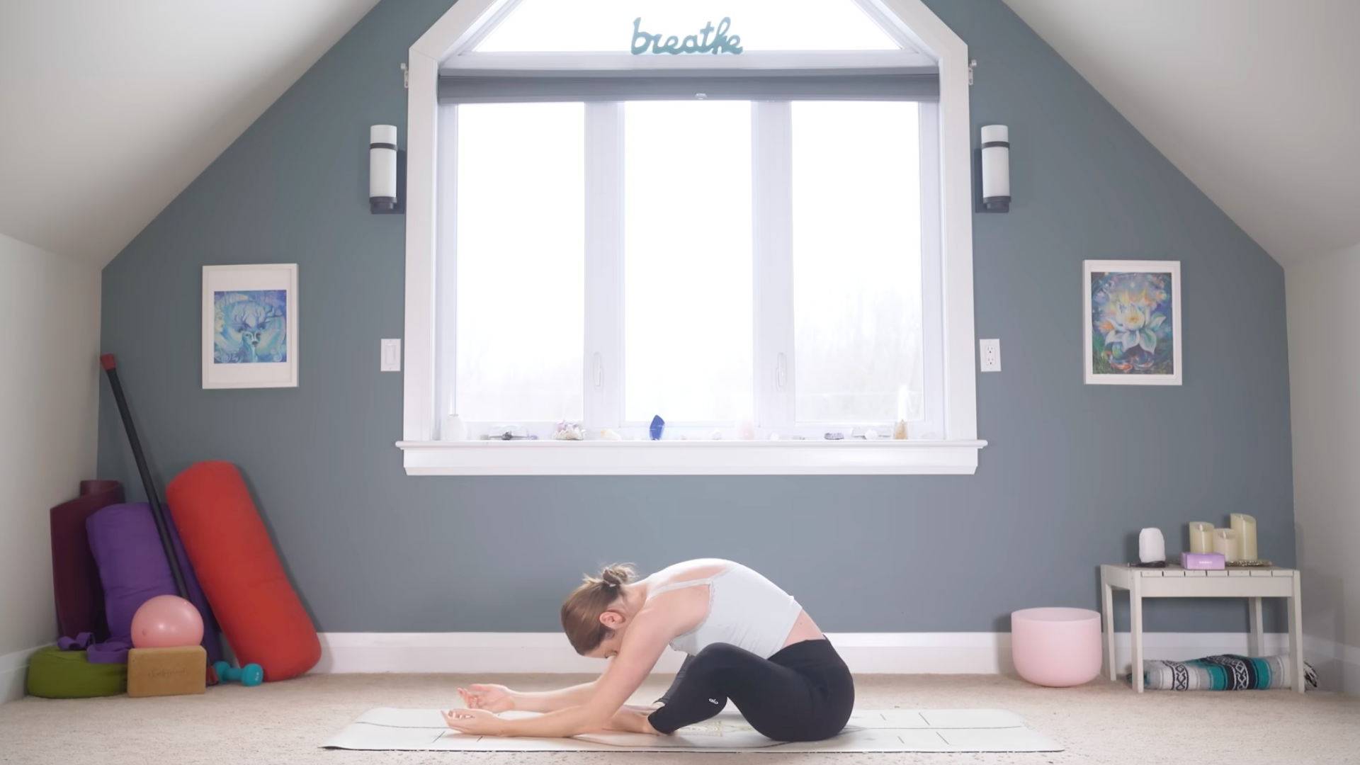 Woman sitting on a yoga mat with knees bent
