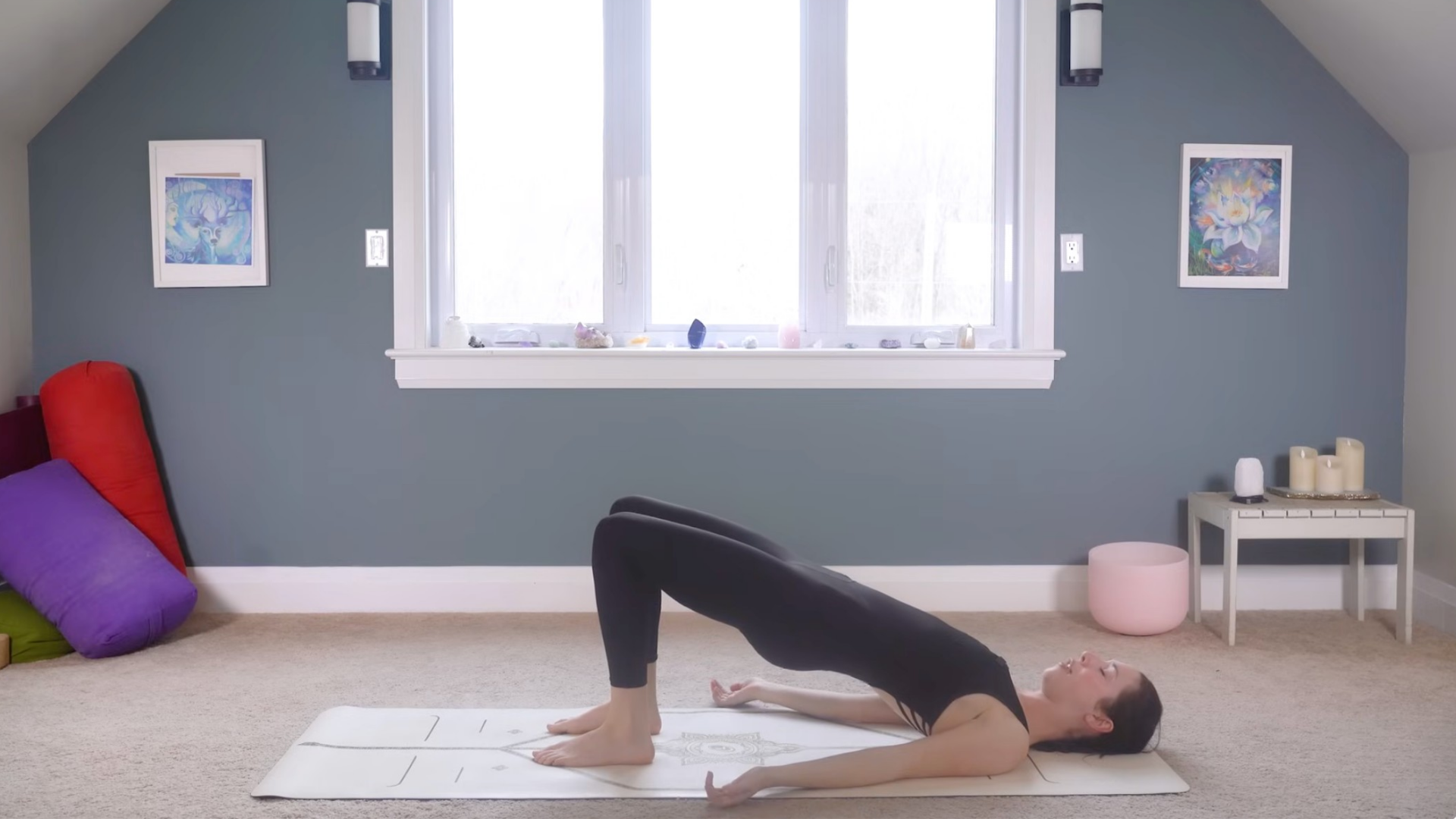 Woman lying back and lifting her hips in Bridge Pose during a 20-minute morning yoga routine