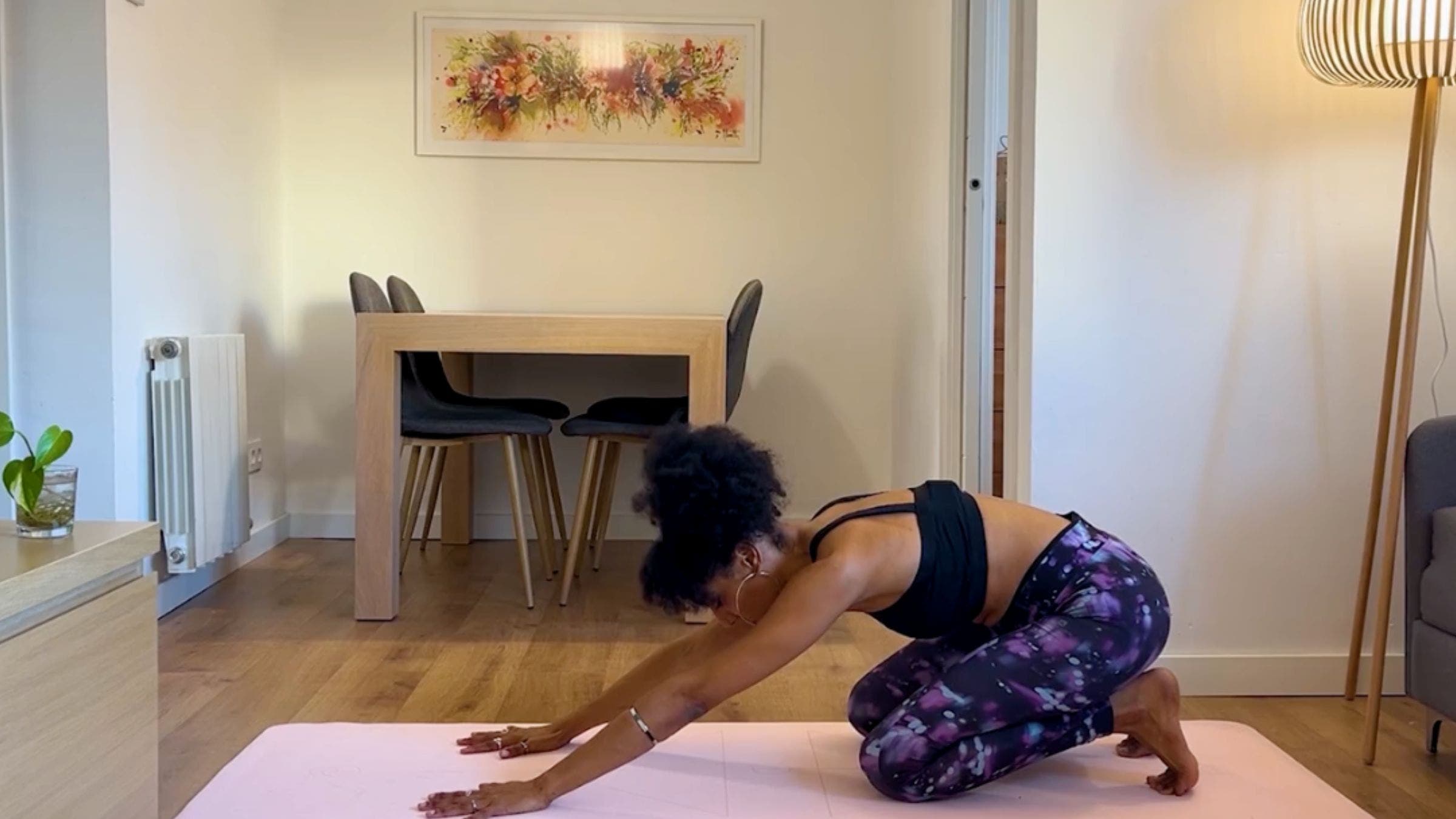 Yoga teacher practicing Child's Pose.