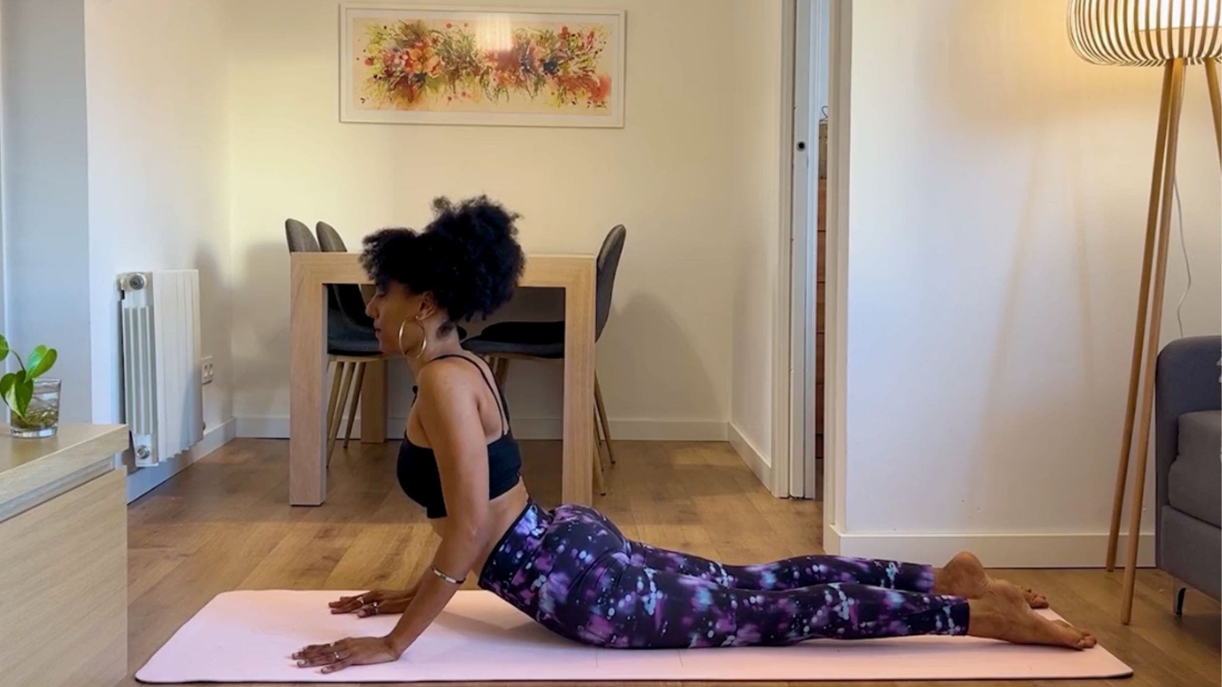 Yoga teacher practicing cobra pose.