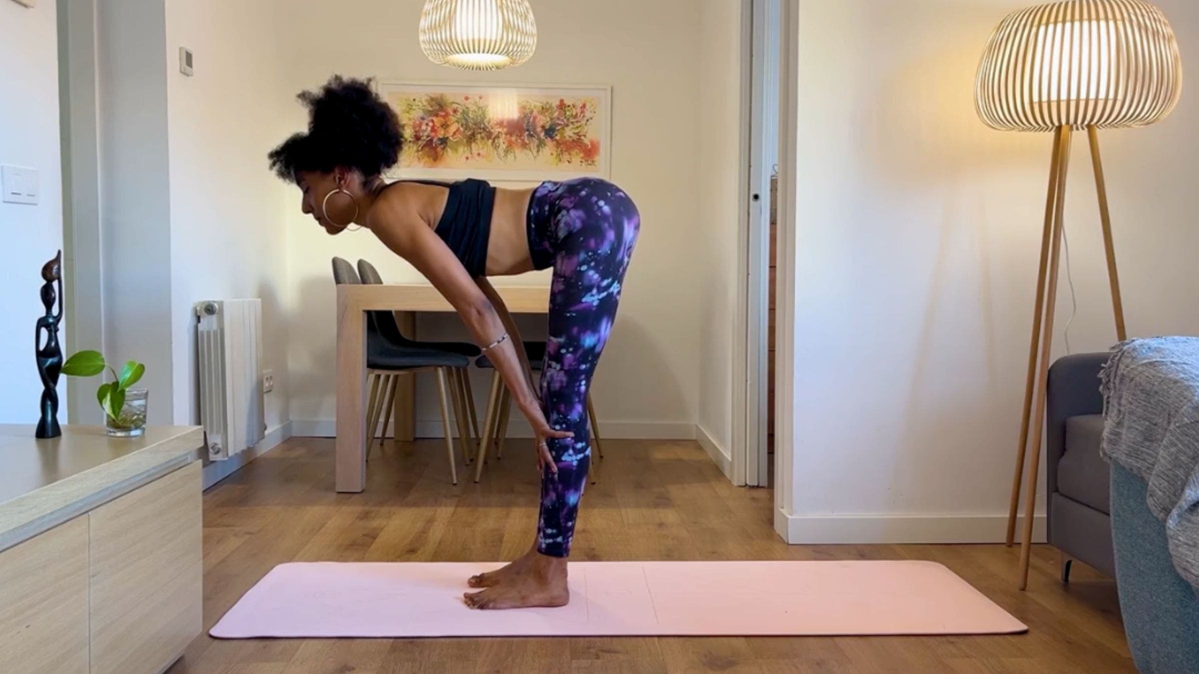 Yoga teacher practicing Half Standing Forward Bend.
