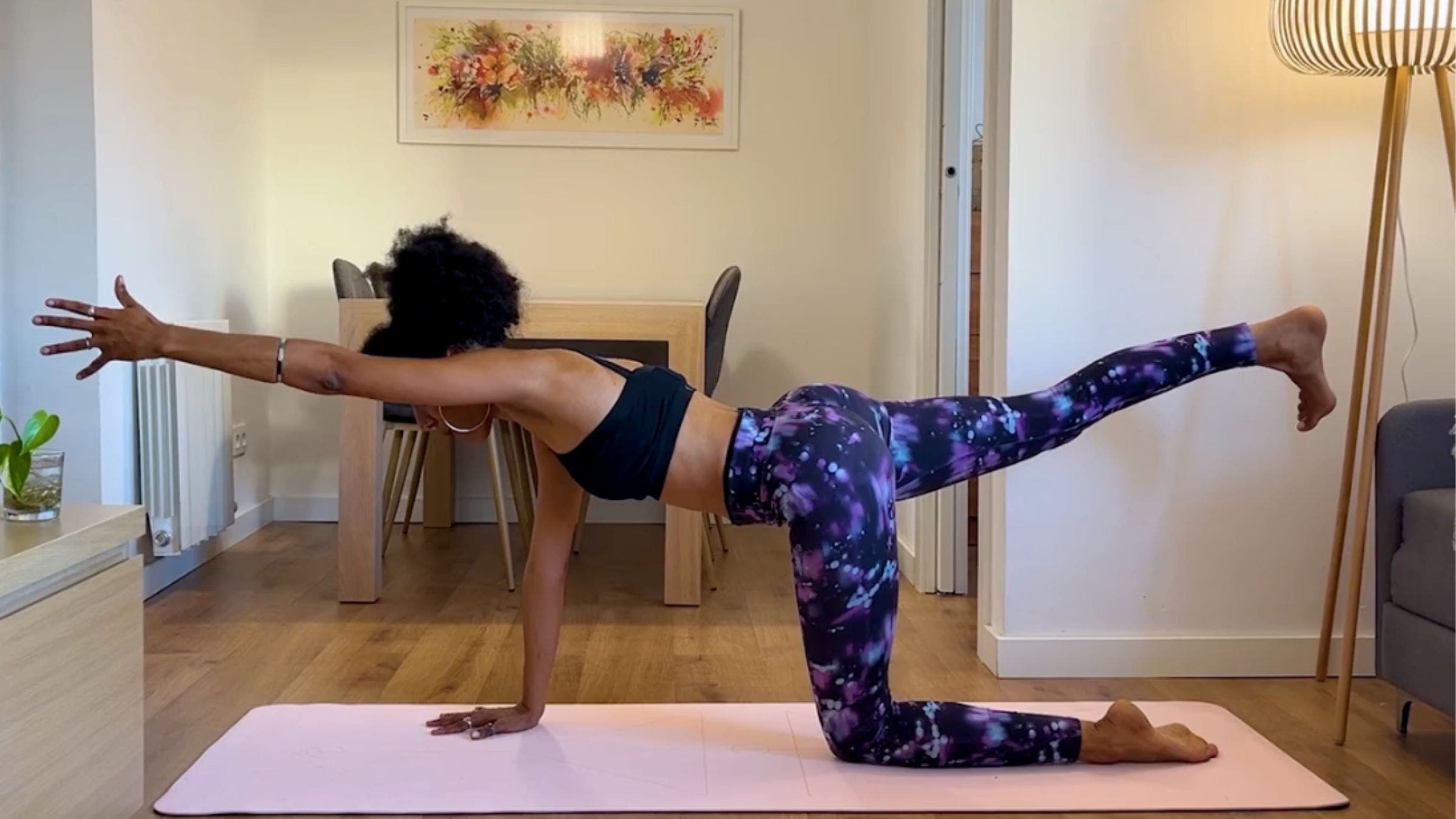 Yoga teacher practicing Bird Dog.
