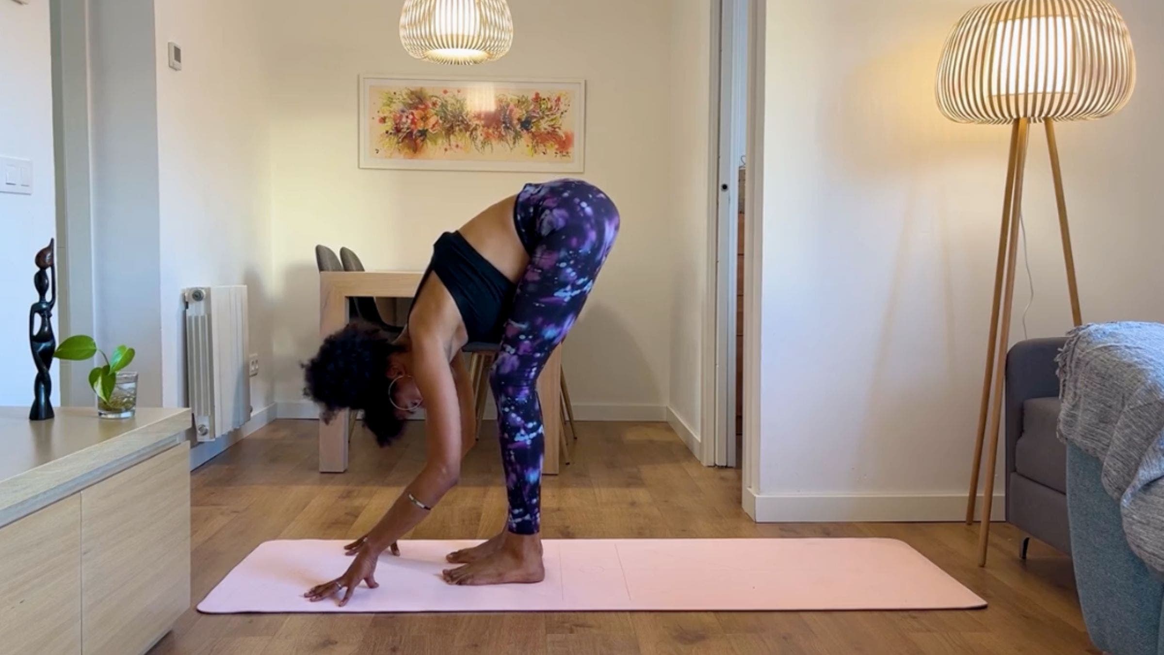Yoga teacher practicing Standing Forward Bend.
