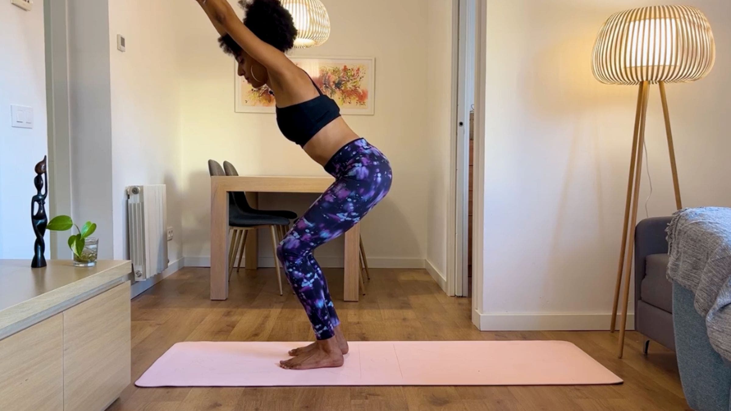 Yoga teacher practicing Chair Pose.